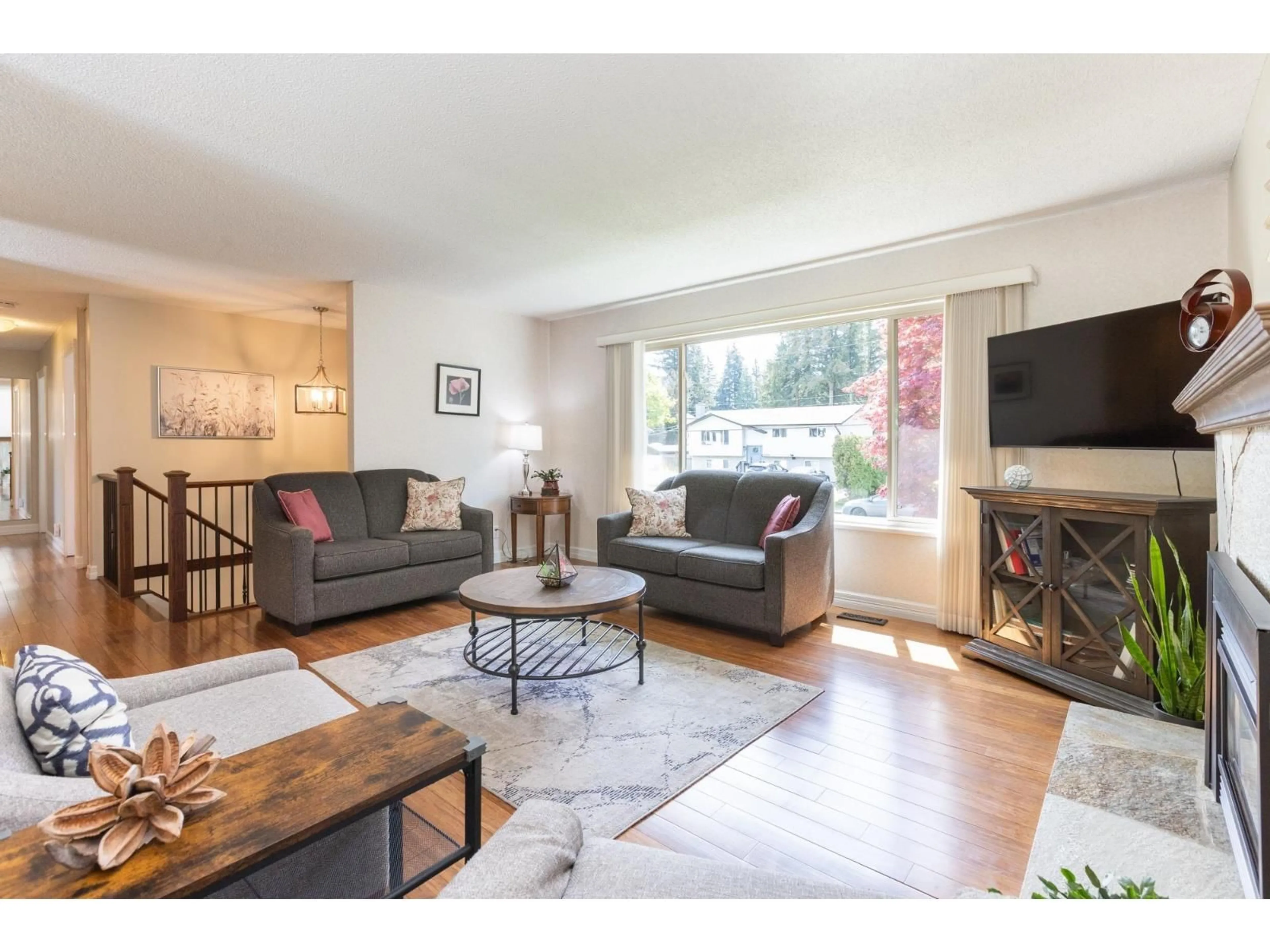 Living room with furniture, wood/laminate floor for 20249 44 AVENUE, Langley British Columbia V3A6L9