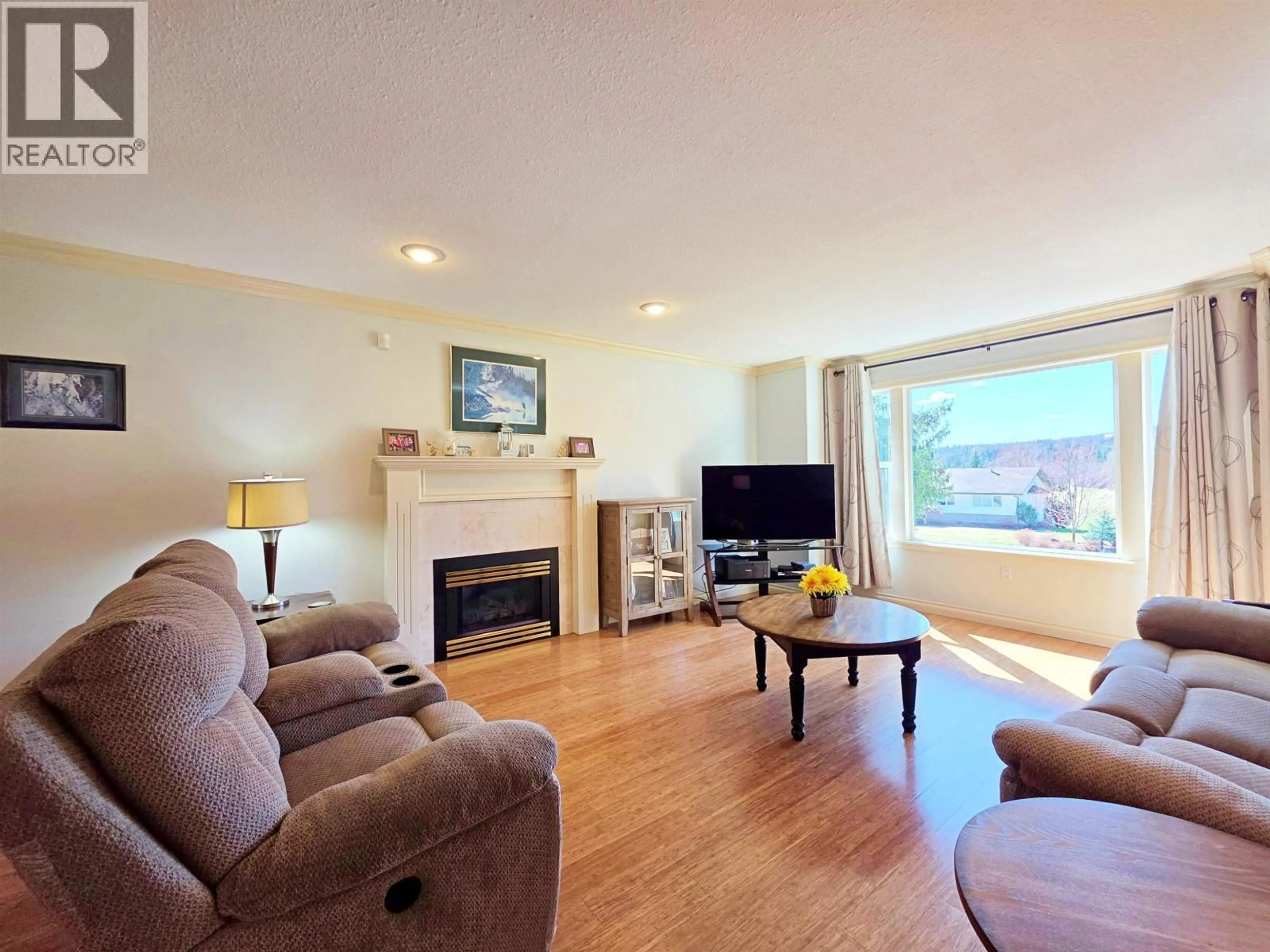 Living room with furniture, wood/laminate floor for 2020 GAMACHE ROAD, Quesnel British Columbia V2J7A8