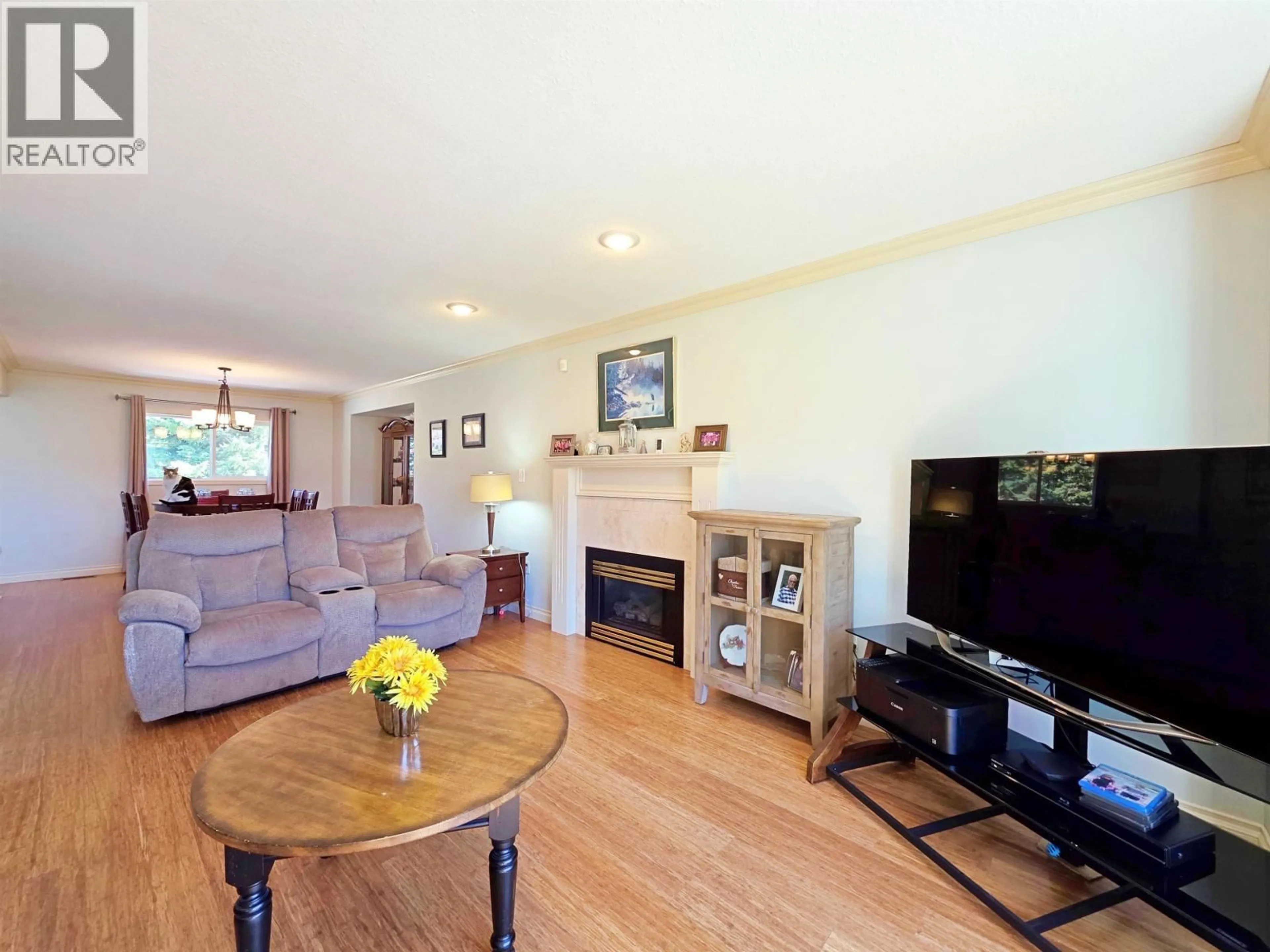 Living room with furniture, wood/laminate floor for 2020 GAMACHE ROAD, Quesnel British Columbia V2J7A8