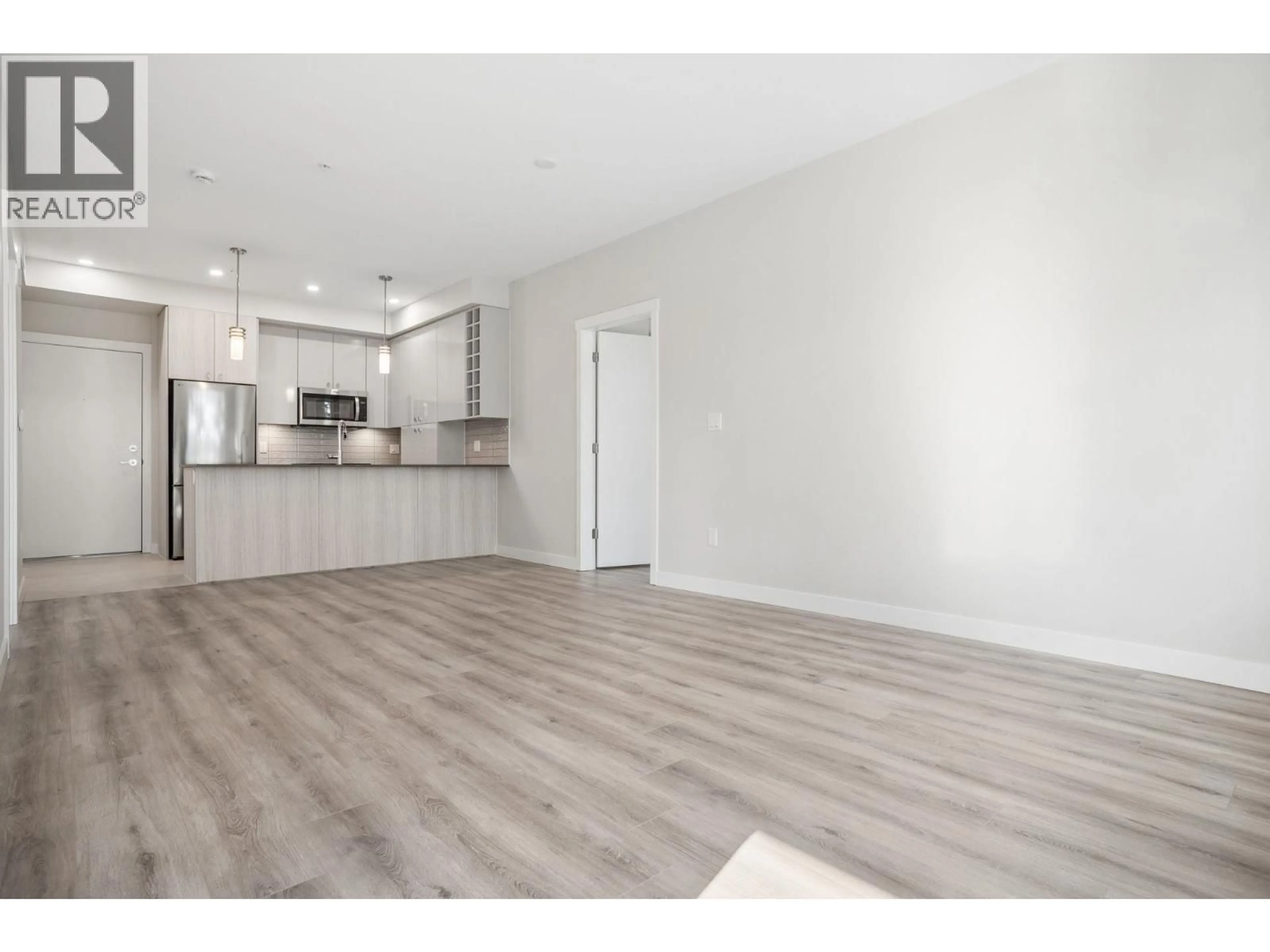 Open concept kitchen, wood/laminate floor for 206 - 23222 GILLEY ROAD, Richmond British Columbia V6V0C8