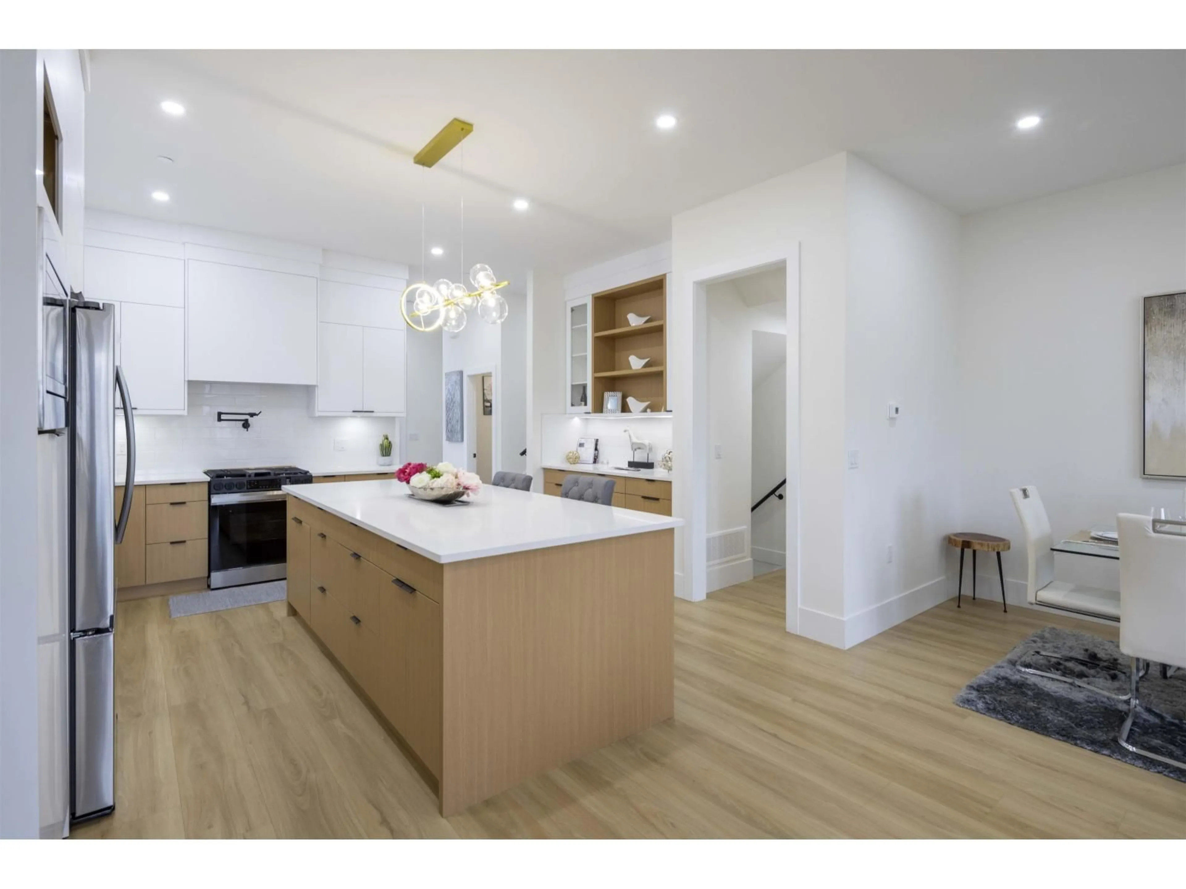 Open concept kitchen, wood/laminate floor for 7707 197 STREET, Langley British Columbia V2Y3T4