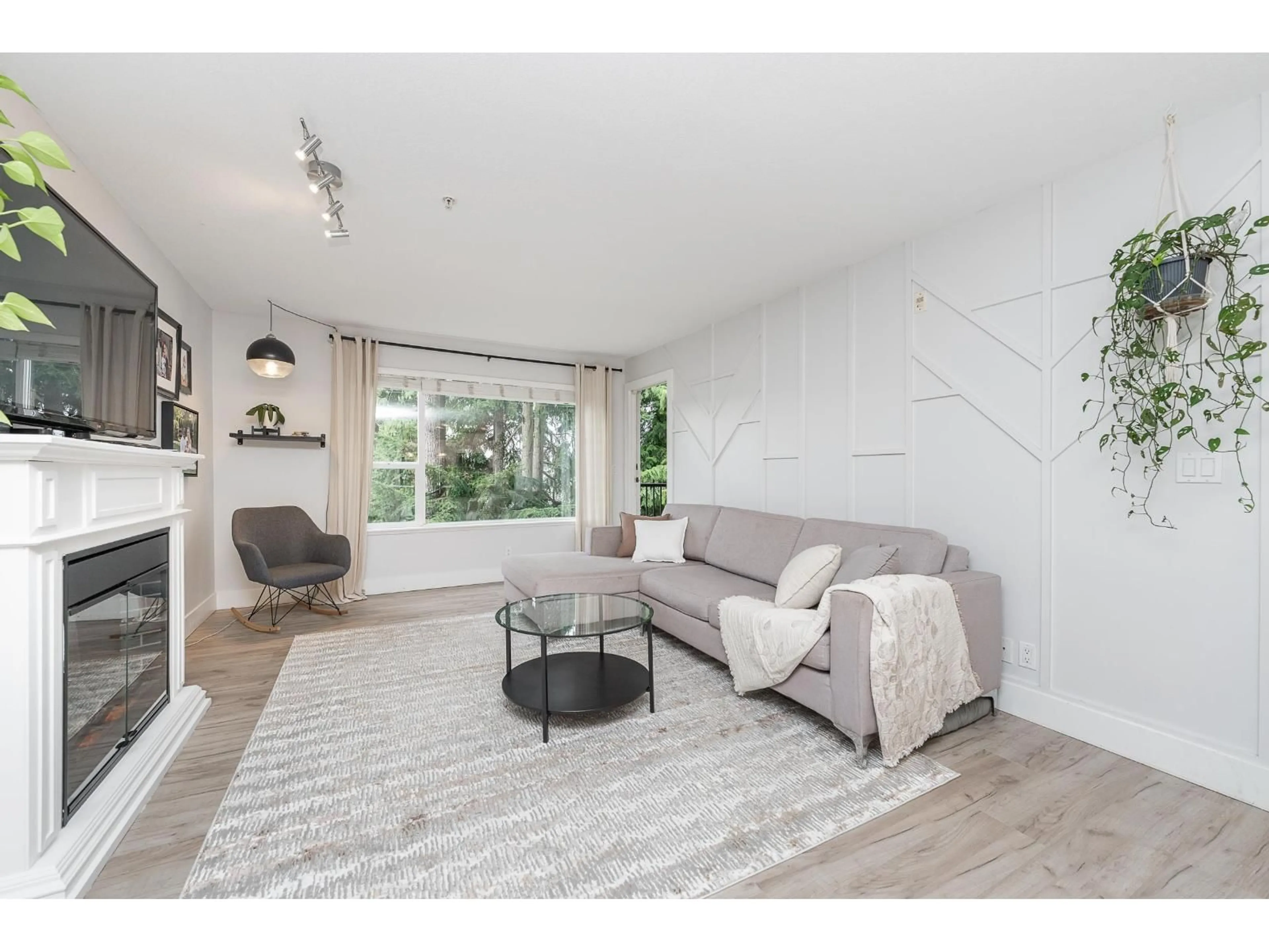 Living room with furniture, wood/laminate floor for 308 - 2581 LANGDON STREET, Abbotsford British Columbia V2T7A3