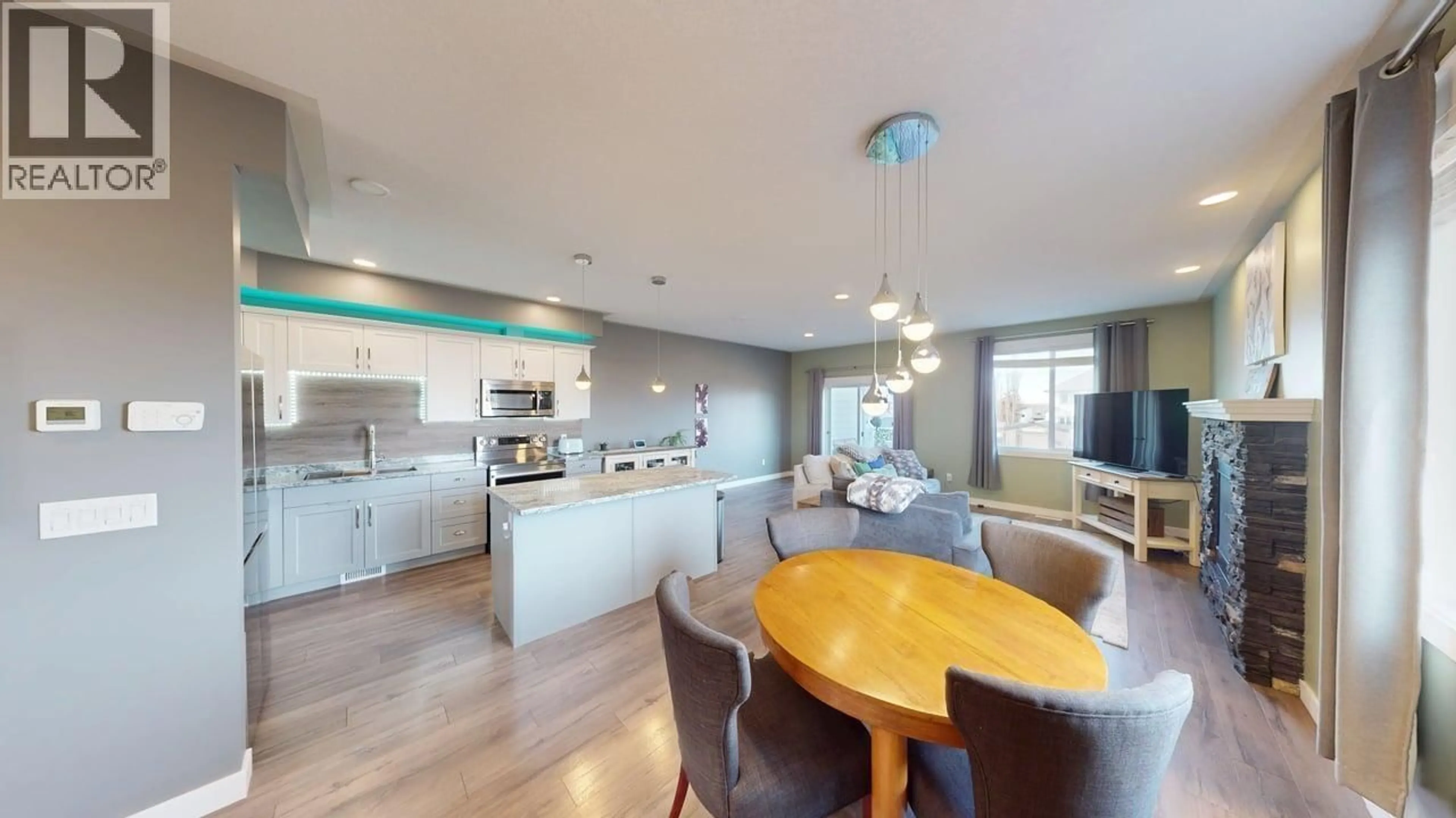 Open concept kitchen, wood/laminate floor for 10010 111 AVENUE, Fort St. John British Columbia V1J2V2