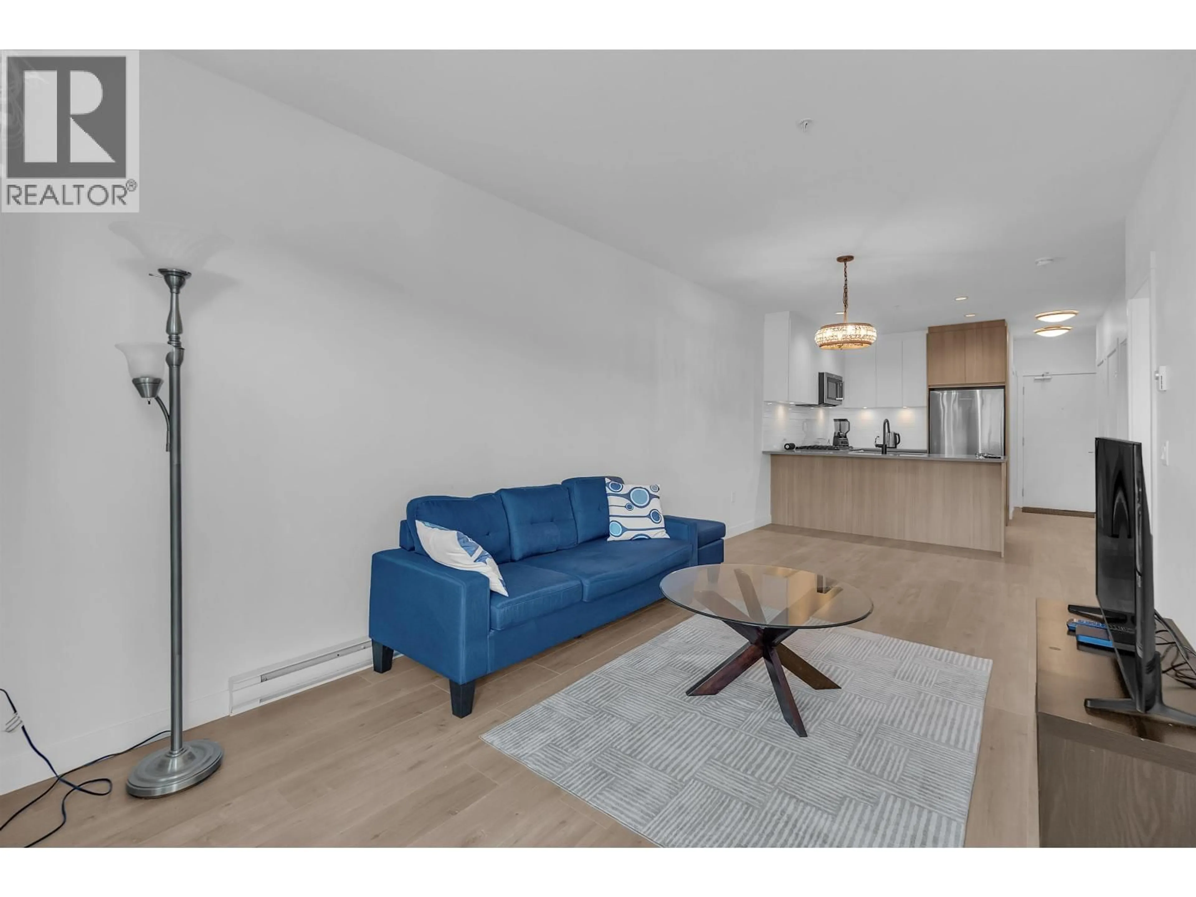 Living room with furniture, wood/laminate floor for 212 - 707 COMO LAKE AVENUE, Coquitlam British Columbia V3J0J5