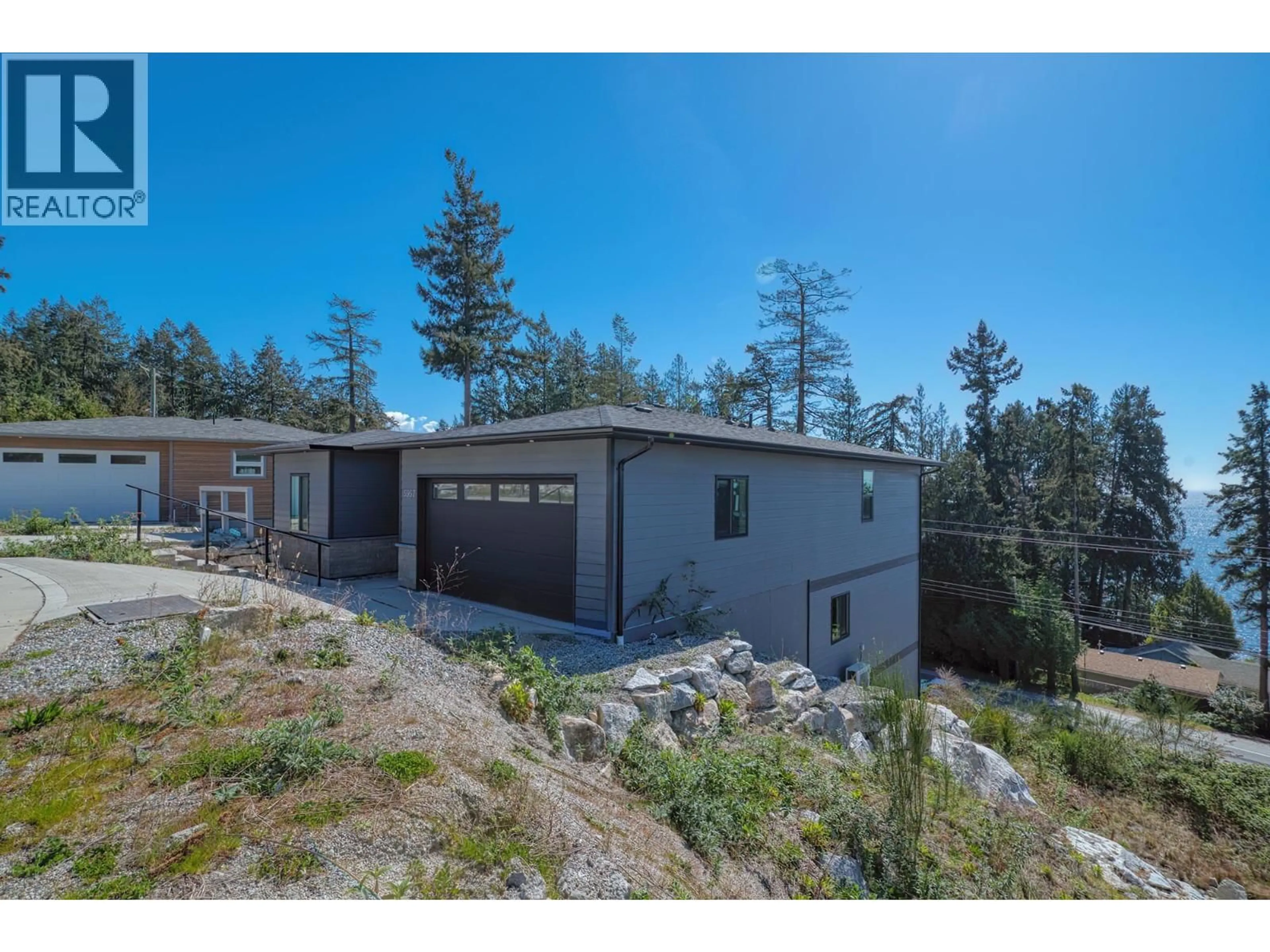 A pic from outside/outdoor area/front of a property/back of a property/a pic from drone, mountain view for 5957 BARNACLE PLACE, Sechelt British Columbia V7Z0V4