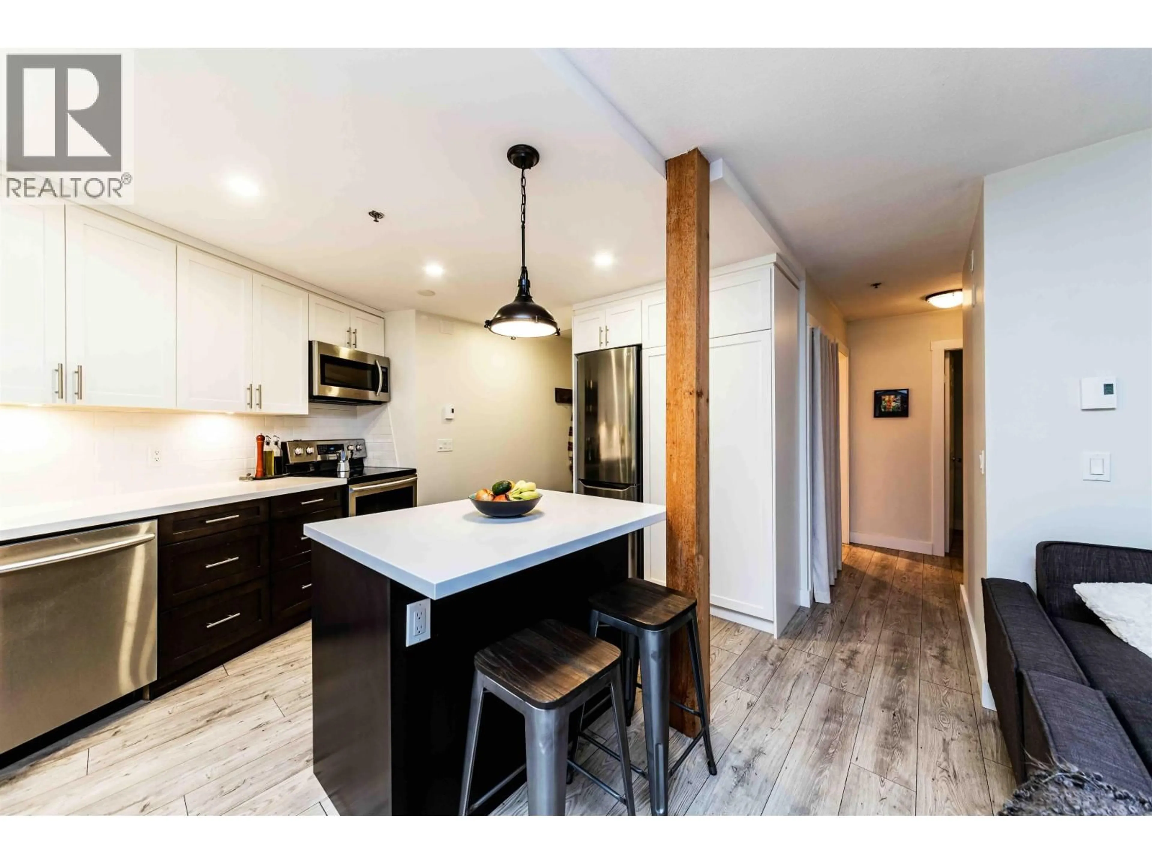 Open concept kitchen, wood/laminate floor for 401 - 2295 PANDORA STREET, Vancouver British Columbia V5L1N6