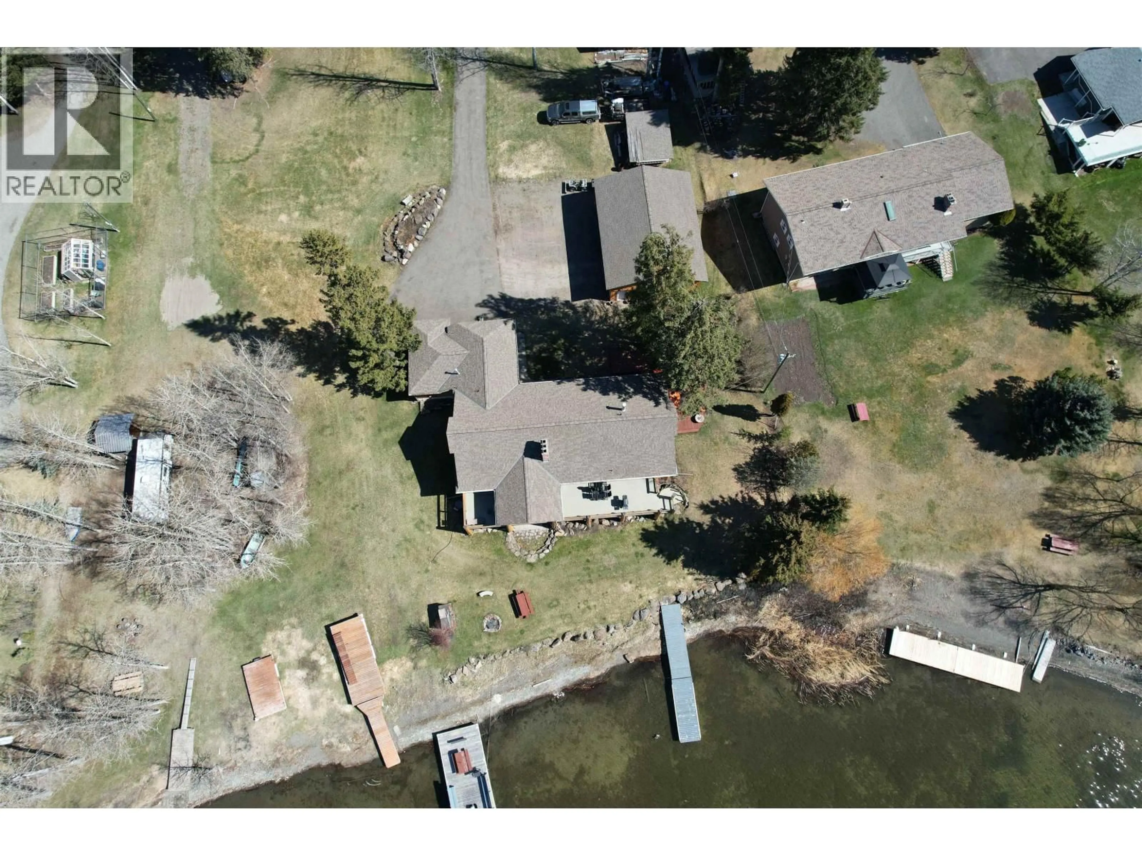 A pic from outside/outdoor area/front of a property/back of a property/a pic from drone, water/lake/river/ocean view for 6126 LAKESHORE DRIVE, 100 Mile House British Columbia V0K2E3