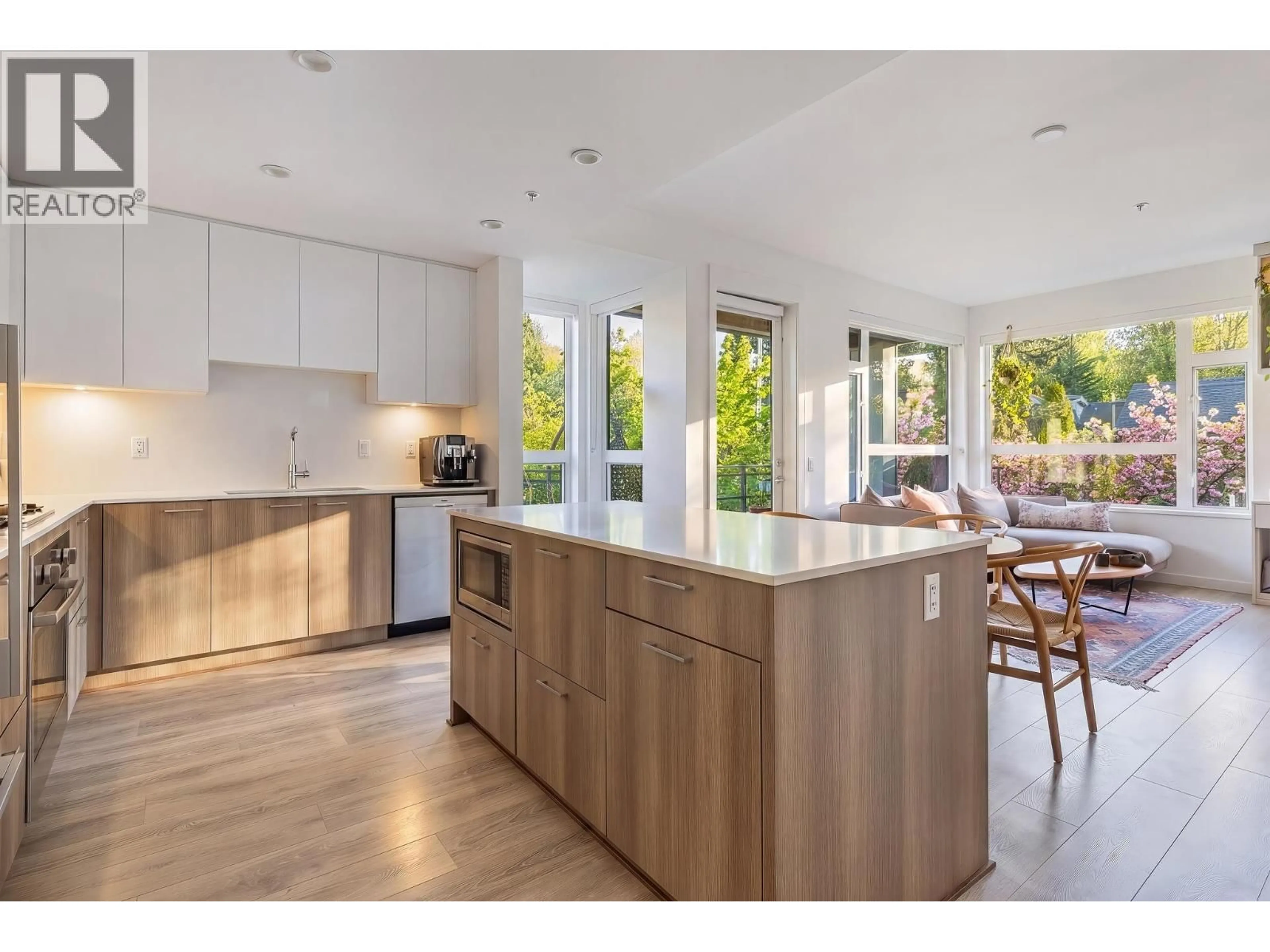 Open concept kitchen, wood/laminate floor for 107 - 715 15TH STREET, North Vancouver British Columbia V7M1T2