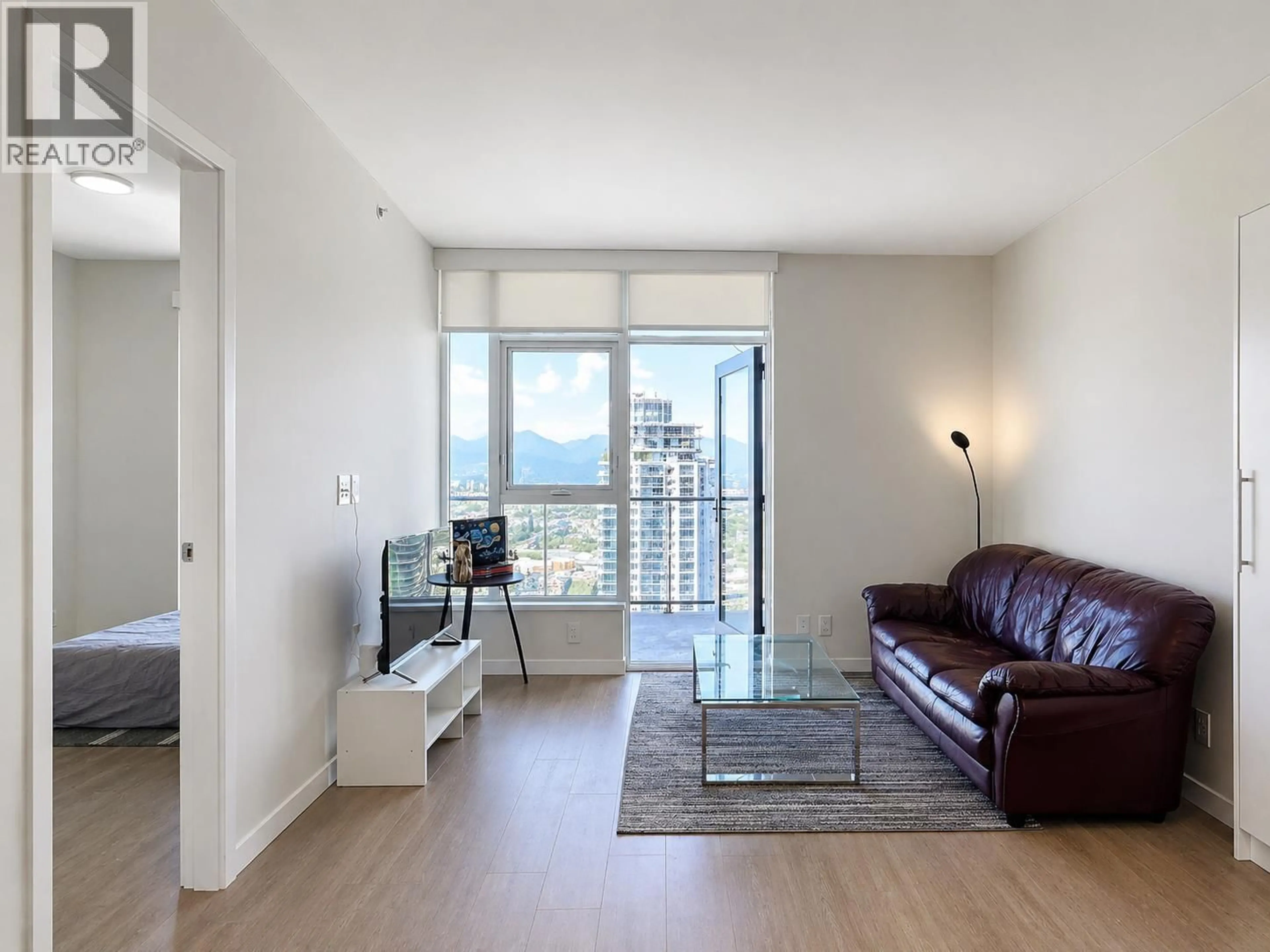 Living room with furniture, wood/laminate floor for 4411 - 2108 GILMORE AVENUE, Burnaby British Columbia V5C0N8