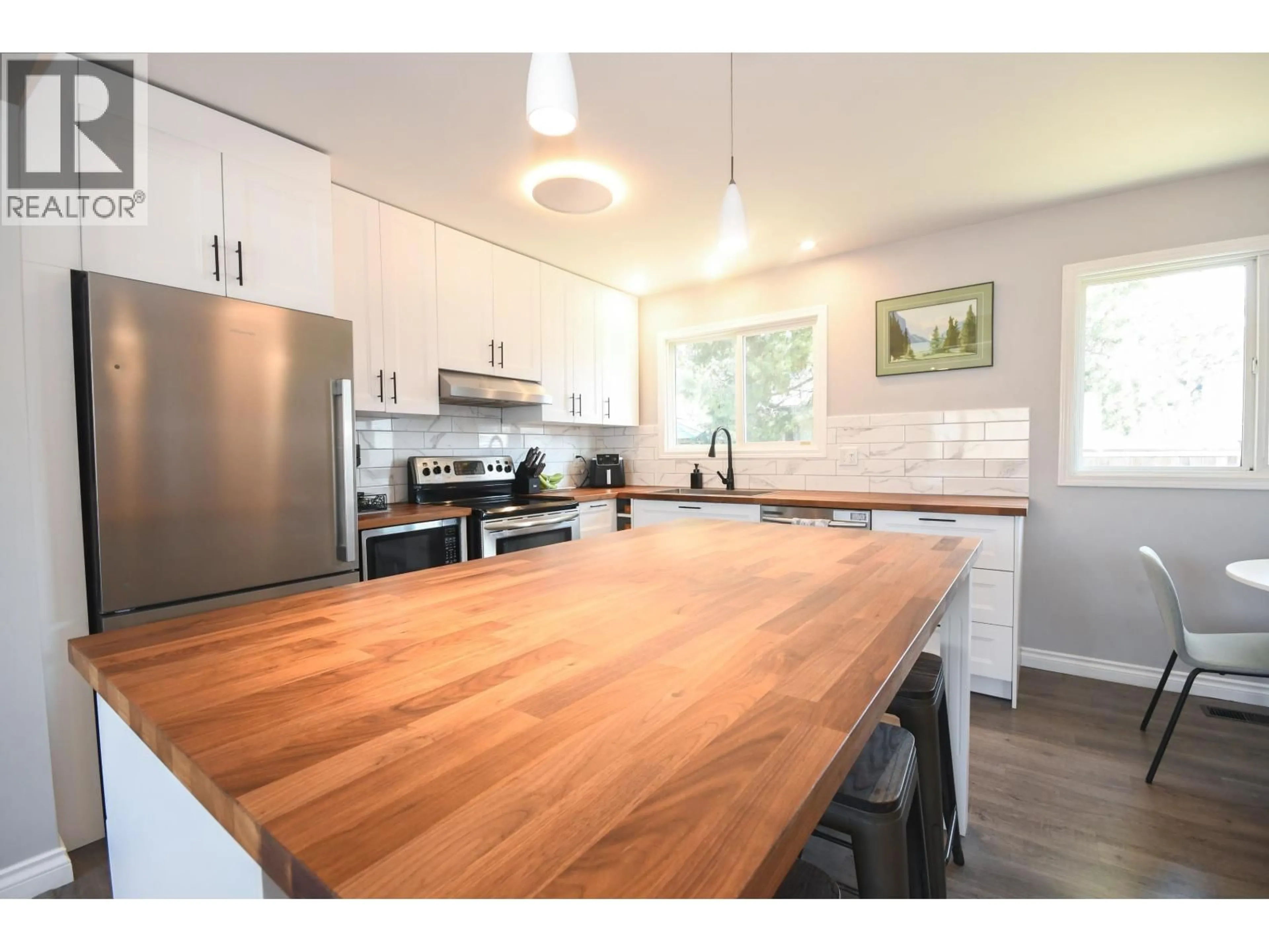 Open concept kitchen, wood/laminate floor for 6033 SELKIRK CRESCENT, Prince George British Columbia V2N2G9