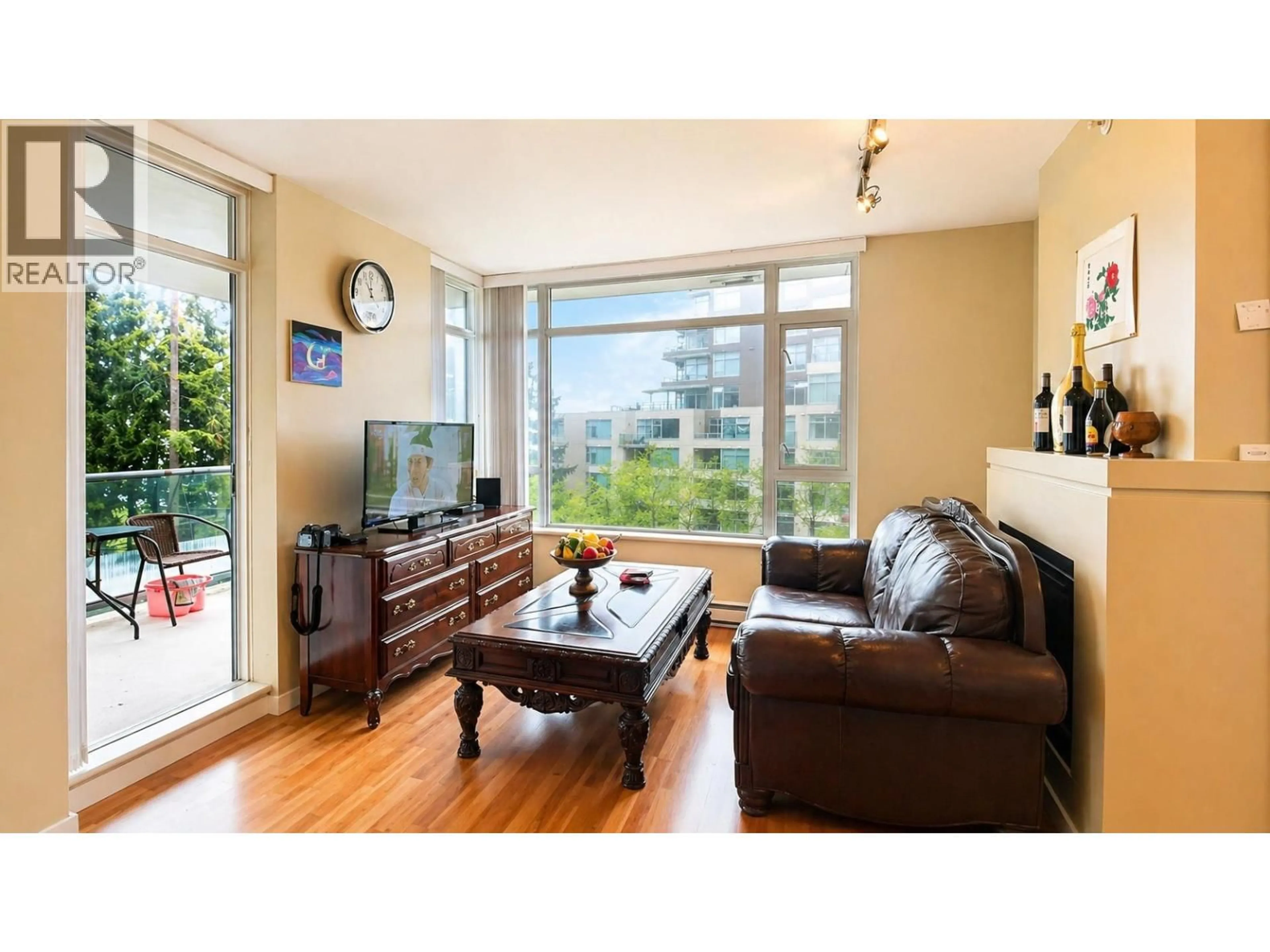 Living room with furniture, wood/laminate floor for 601 - 9266 UNIVERSITY CRESCENT, Burnaby British Columbia V5A4Z1