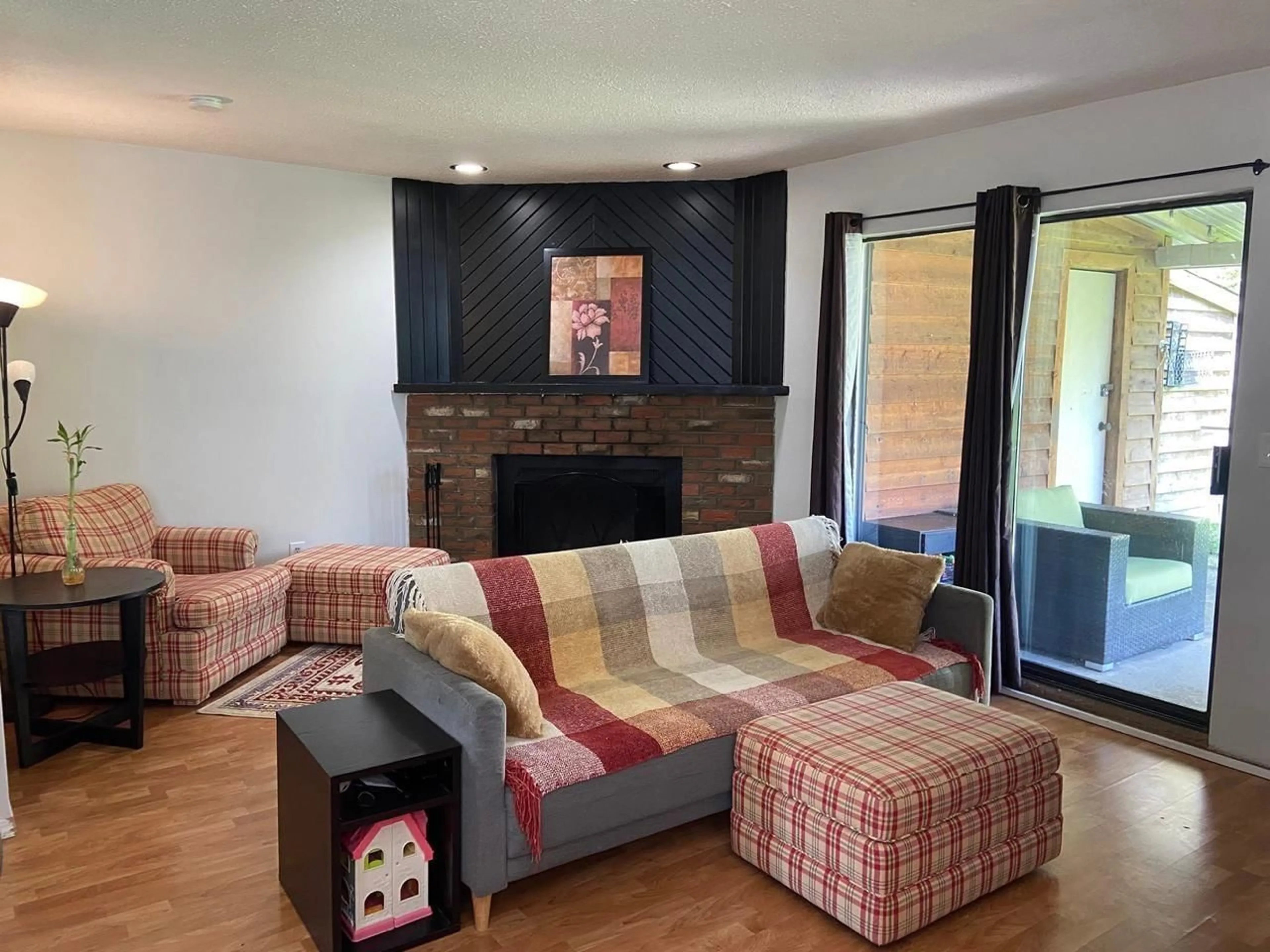 Living room with furniture, wood/laminate floor for 19883 53 AVENUE, Langley British Columbia V3A6W2