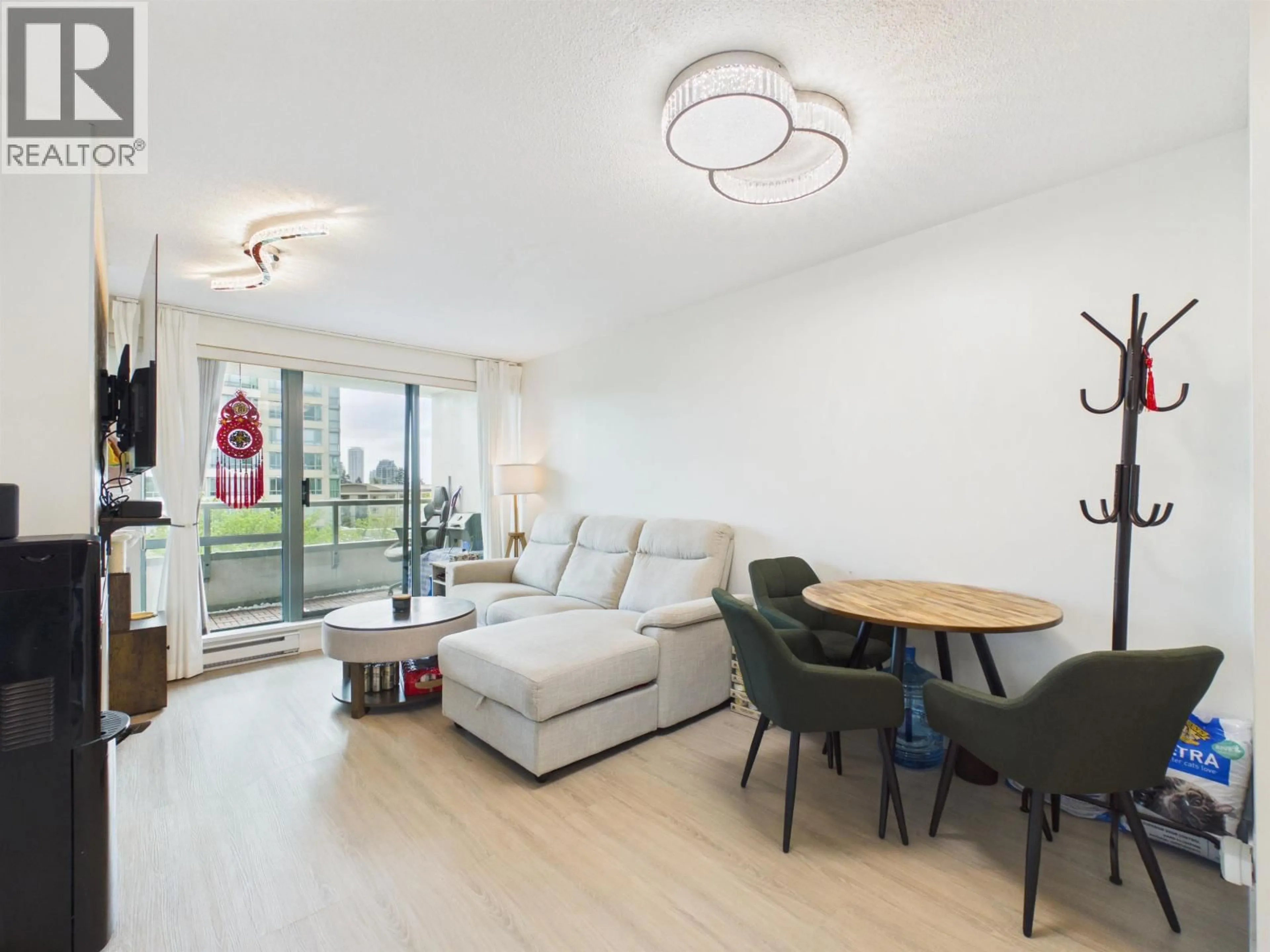 Living room with furniture, wood/laminate floor for 501 - 6611 SOUTHOAKS CRESCENT, Burnaby British Columbia V5E4L5