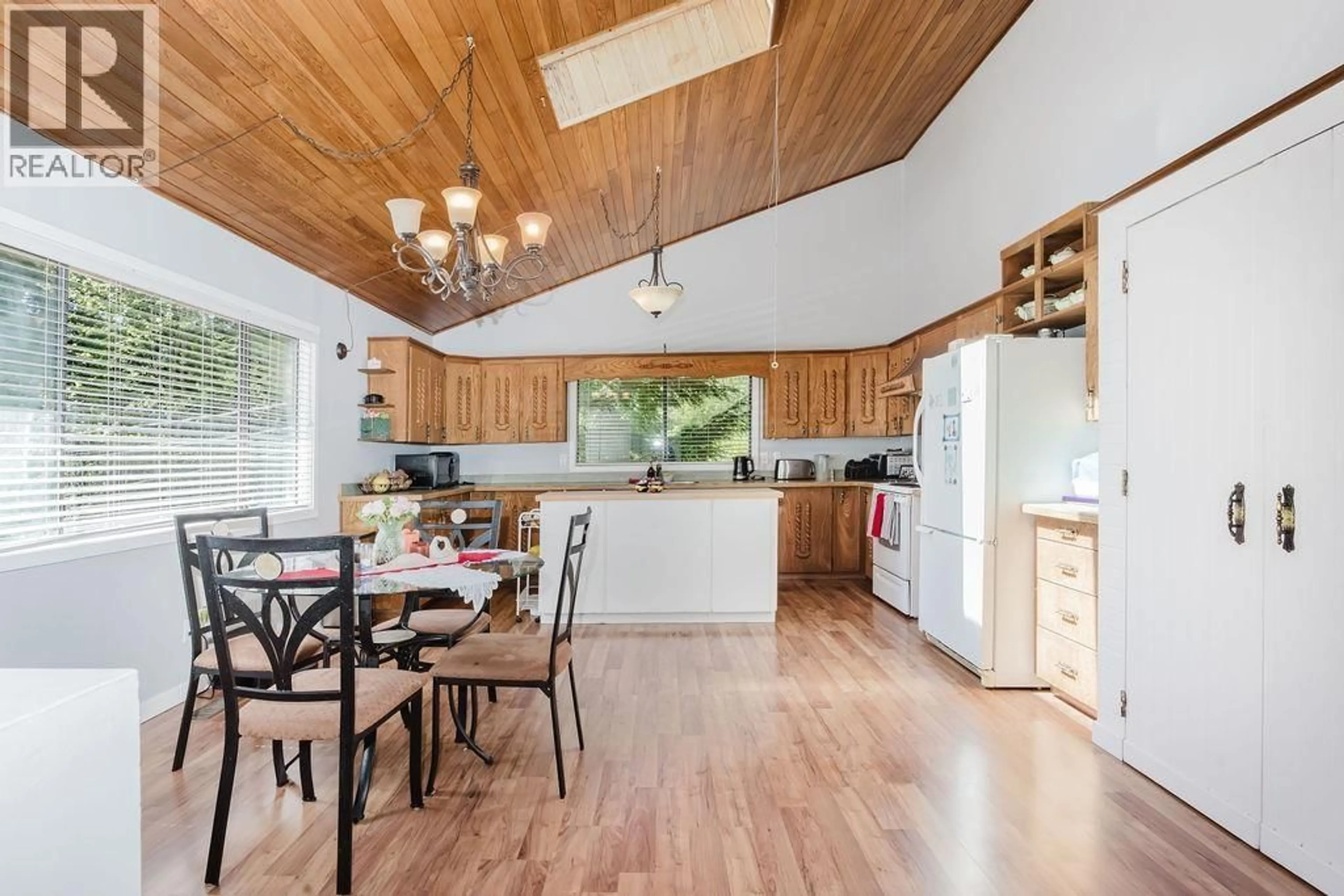 Open concept kitchen, wood/laminate floor for 5899 SPRIGGS ROAD, Madeira Park British Columbia V0N2H0