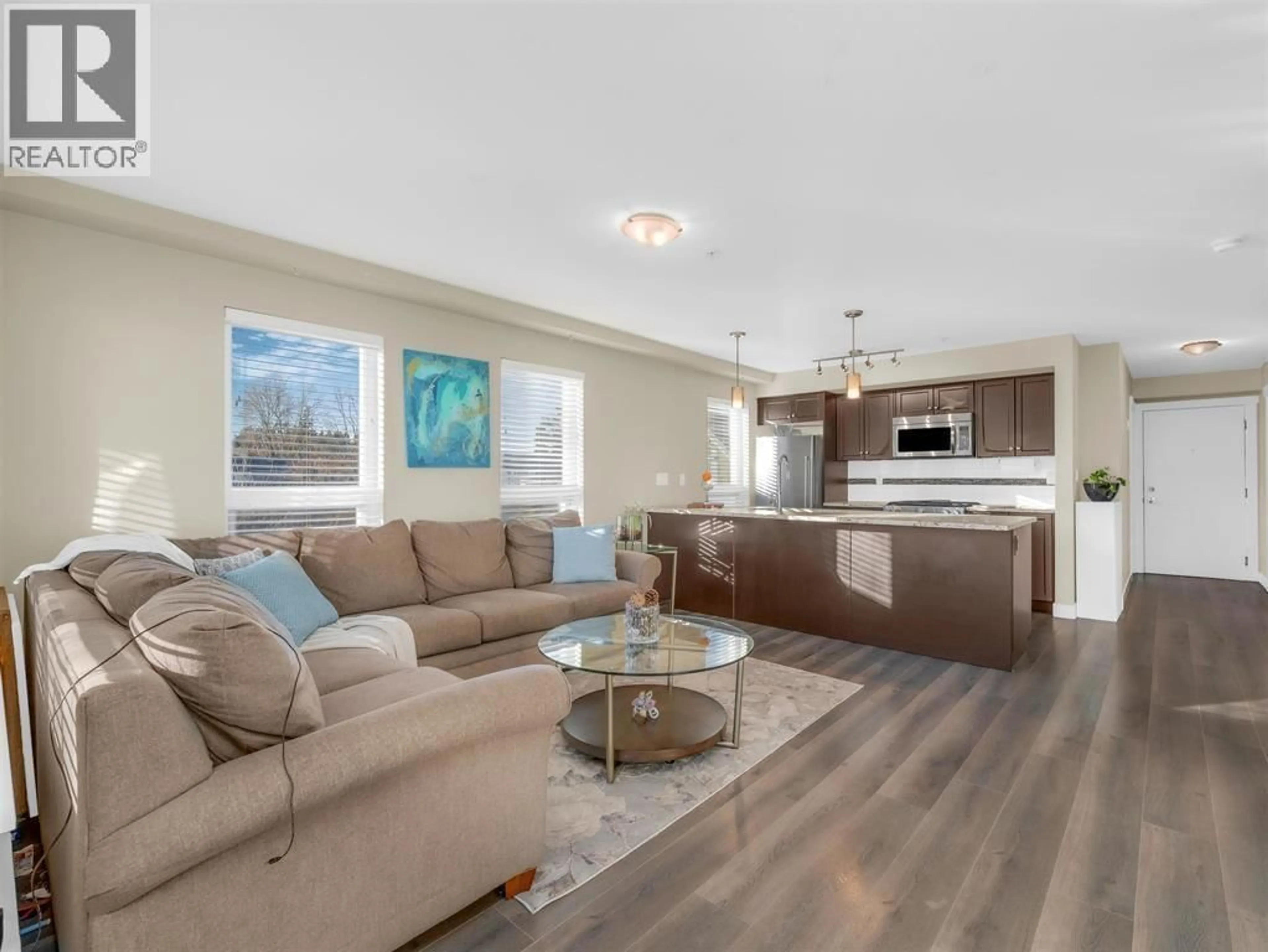 Living room with furniture, wood/laminate floor for 105 - 4815 55B STREET, Delta British Columbia V4K3V7
