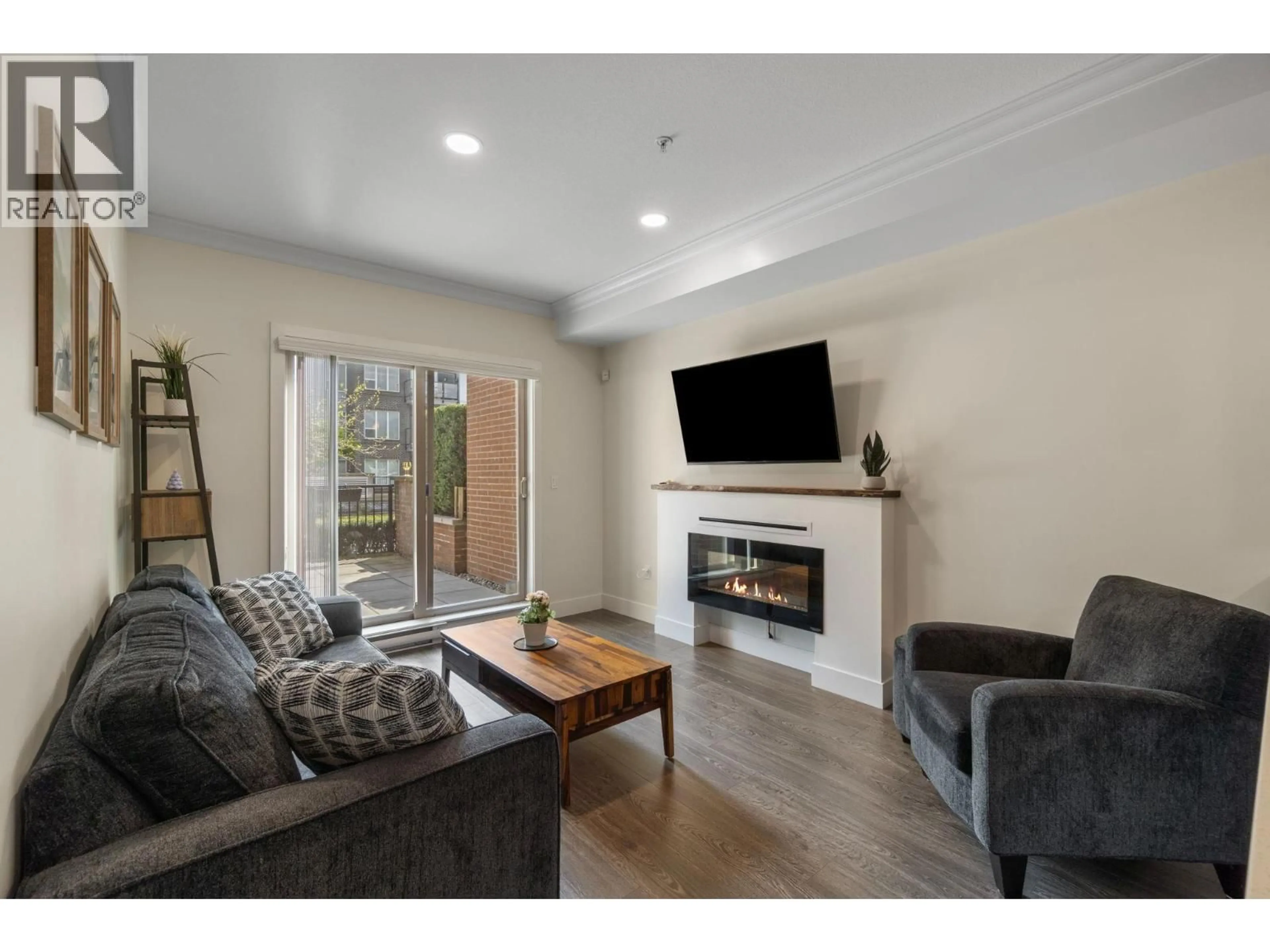 Living room with furniture, wood/laminate floor for 104 - 2349 WELCHER AVENUE, Port Coquitlam British Columbia V3C1X6