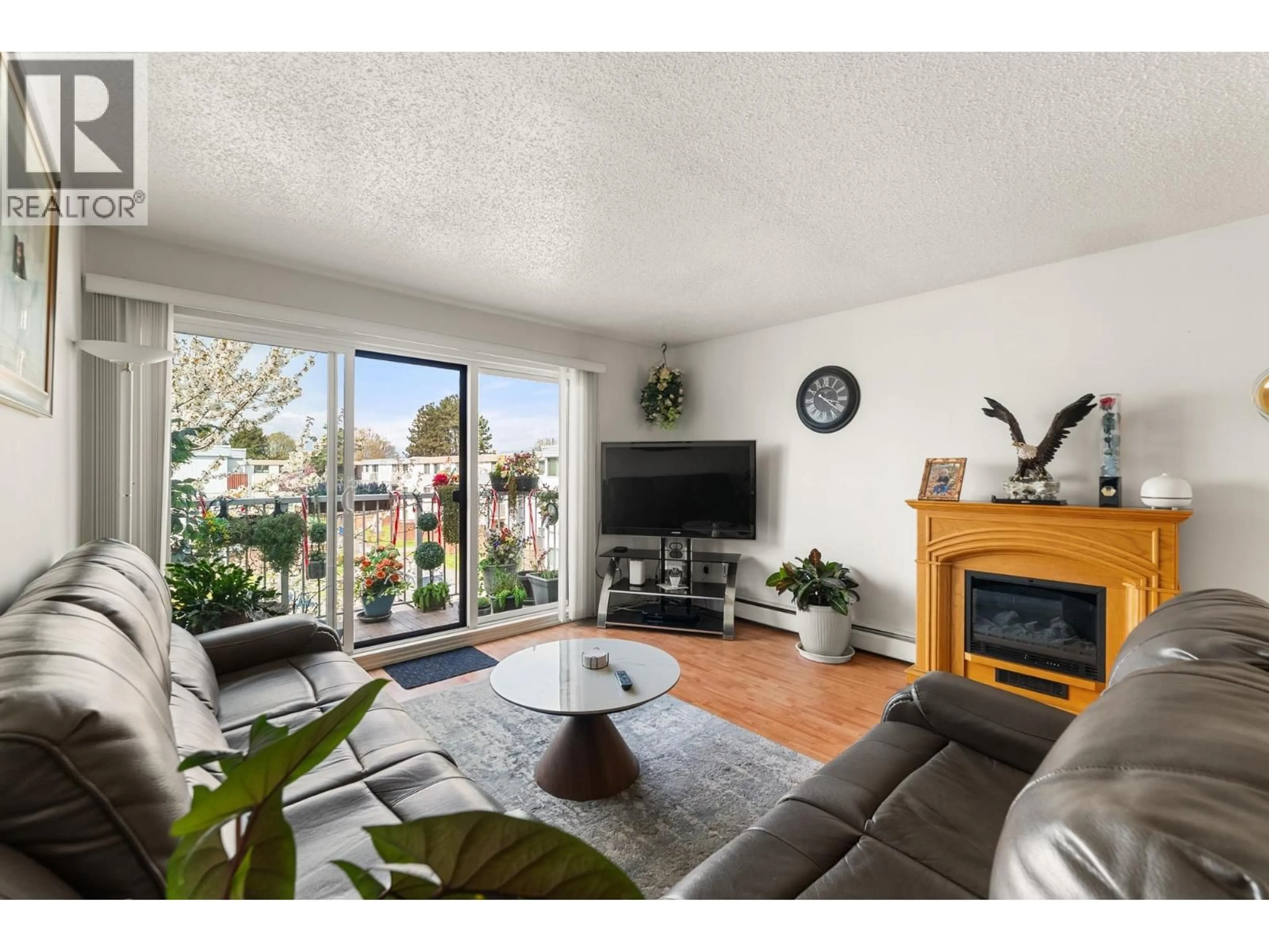 Living room with furniture, wood/laminate floor for 306 - 7240 LINDSAY ROAD, Richmond British Columbia V7C3M6