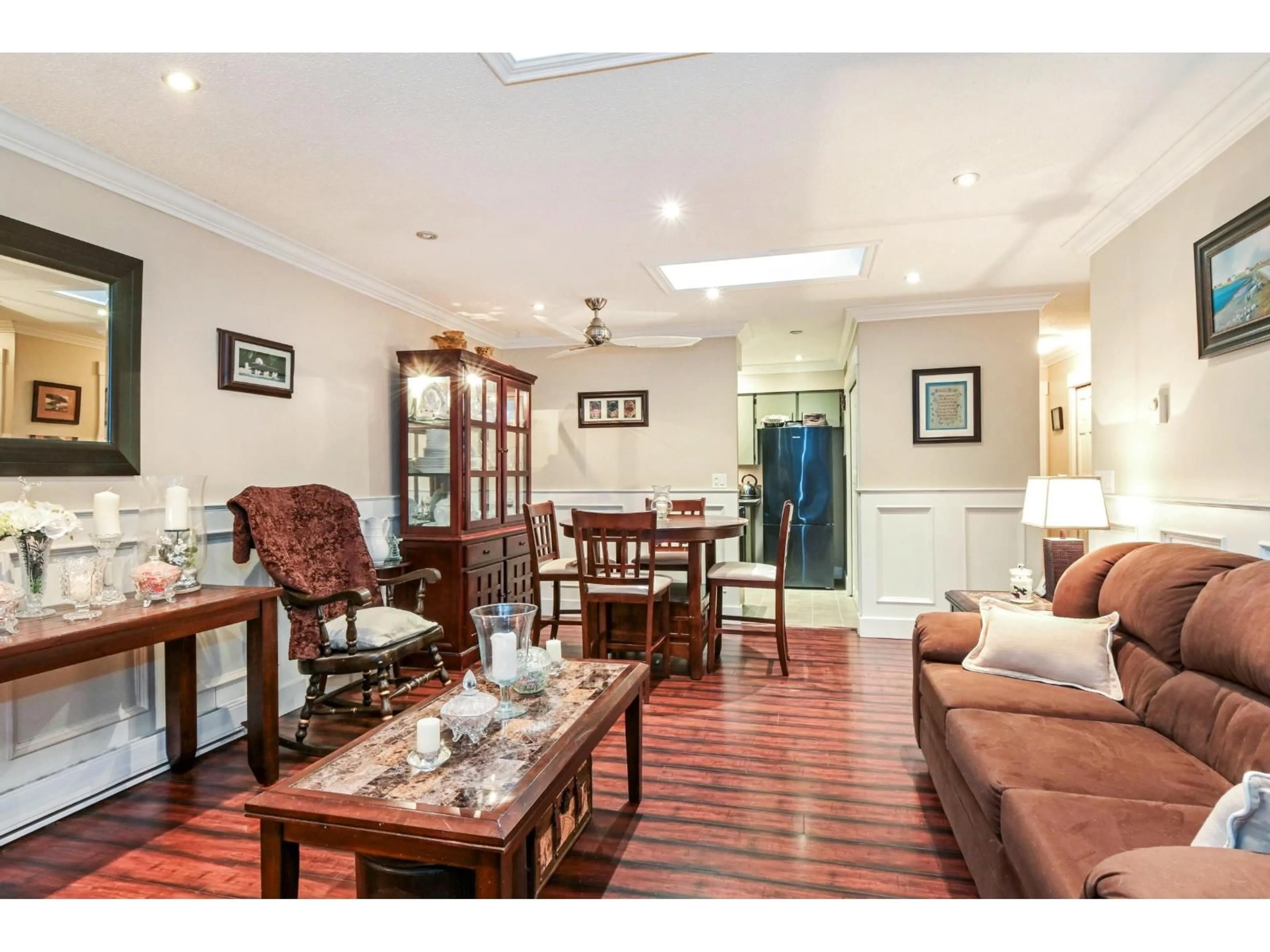 Living room with furniture, wood/laminate floor for 8037 139A STREET, Surrey British Columbia V3W6P9