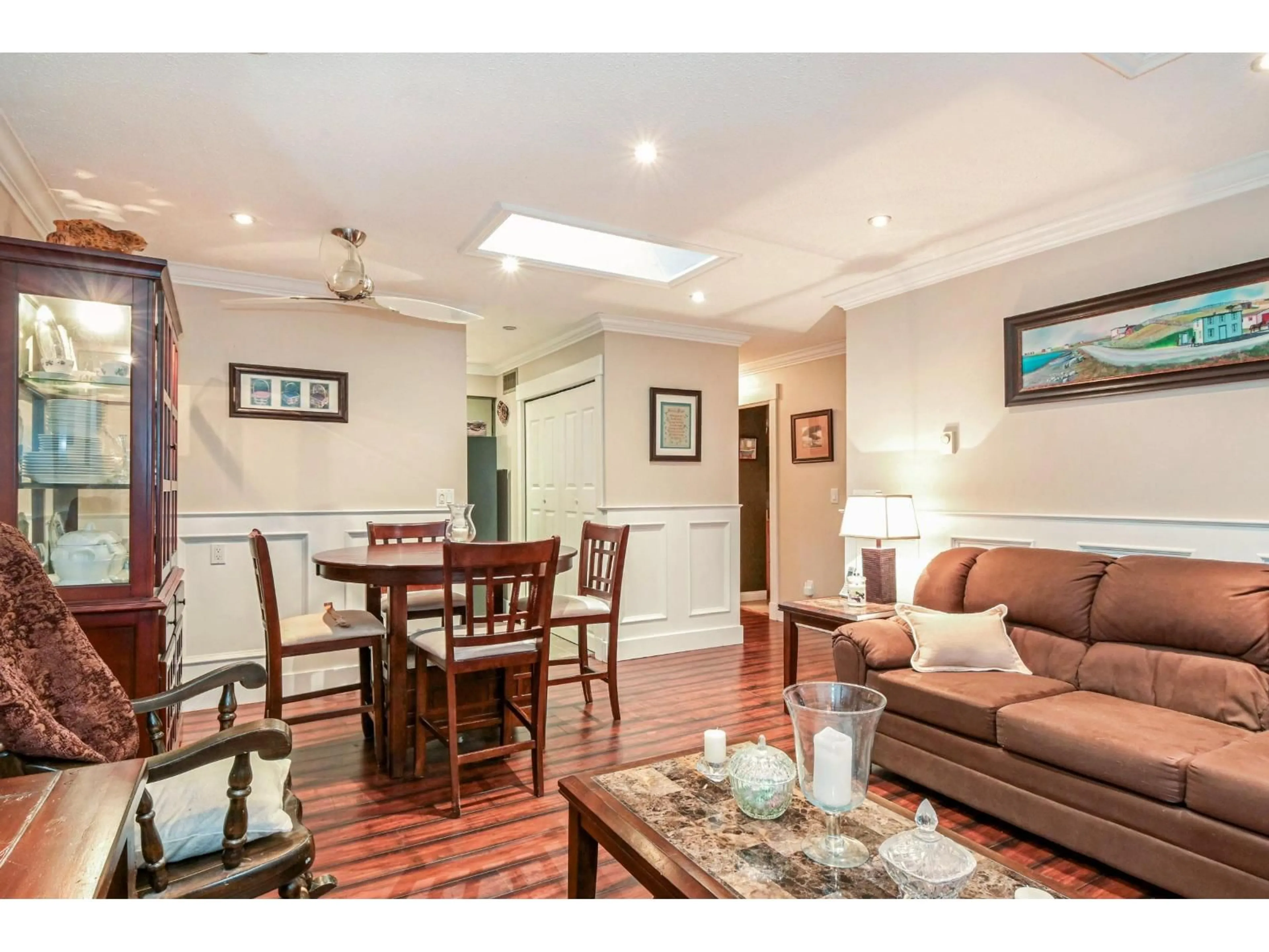 Living room with furniture, wood/laminate floor for 8037 139A STREET, Surrey British Columbia V3W6P9