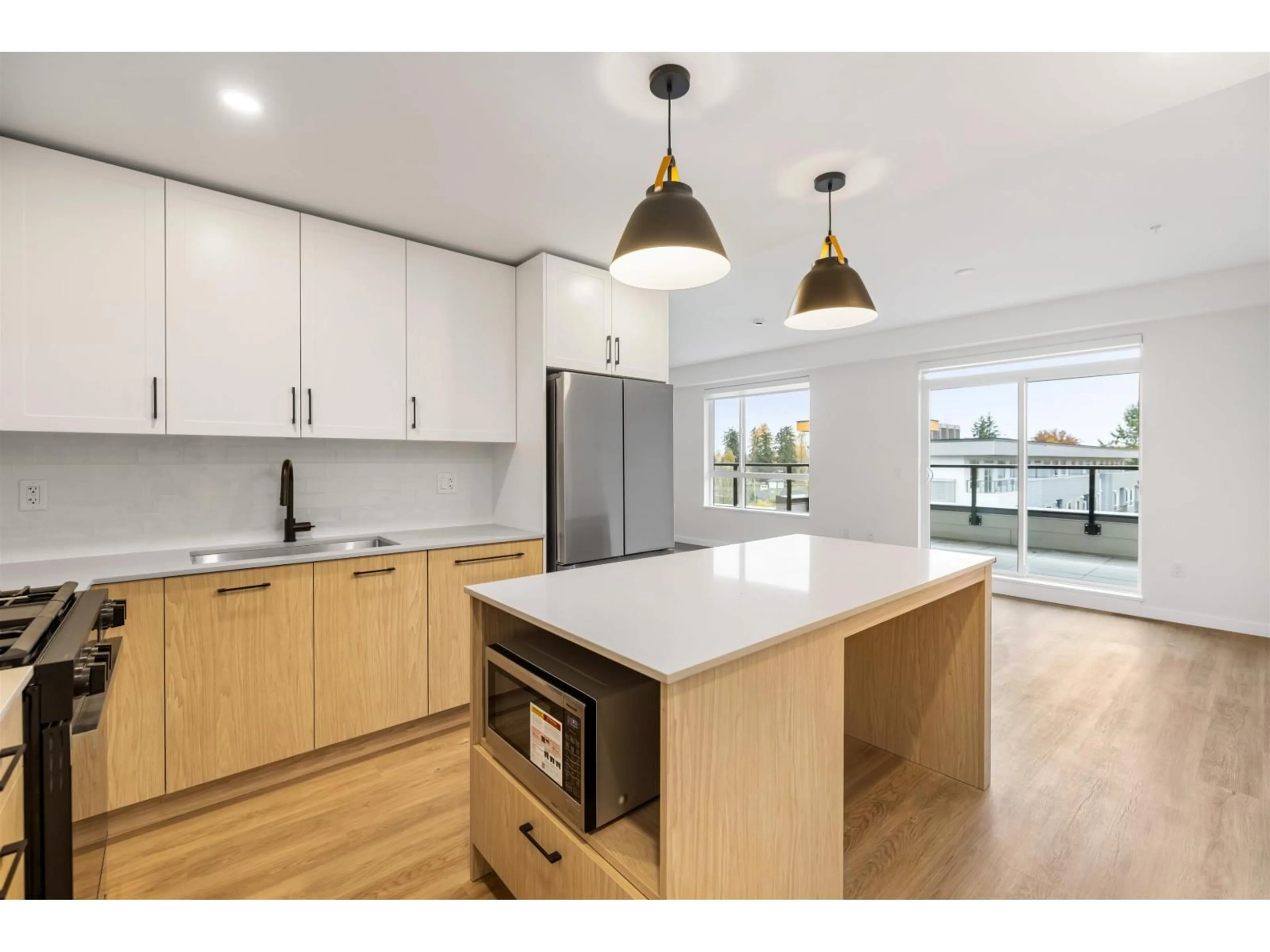 Open concept kitchen, wood/laminate floor for 601 - 27218 ALDERGROVE TOWN CENTER DRIVE, Langley British Columbia V4W0E4