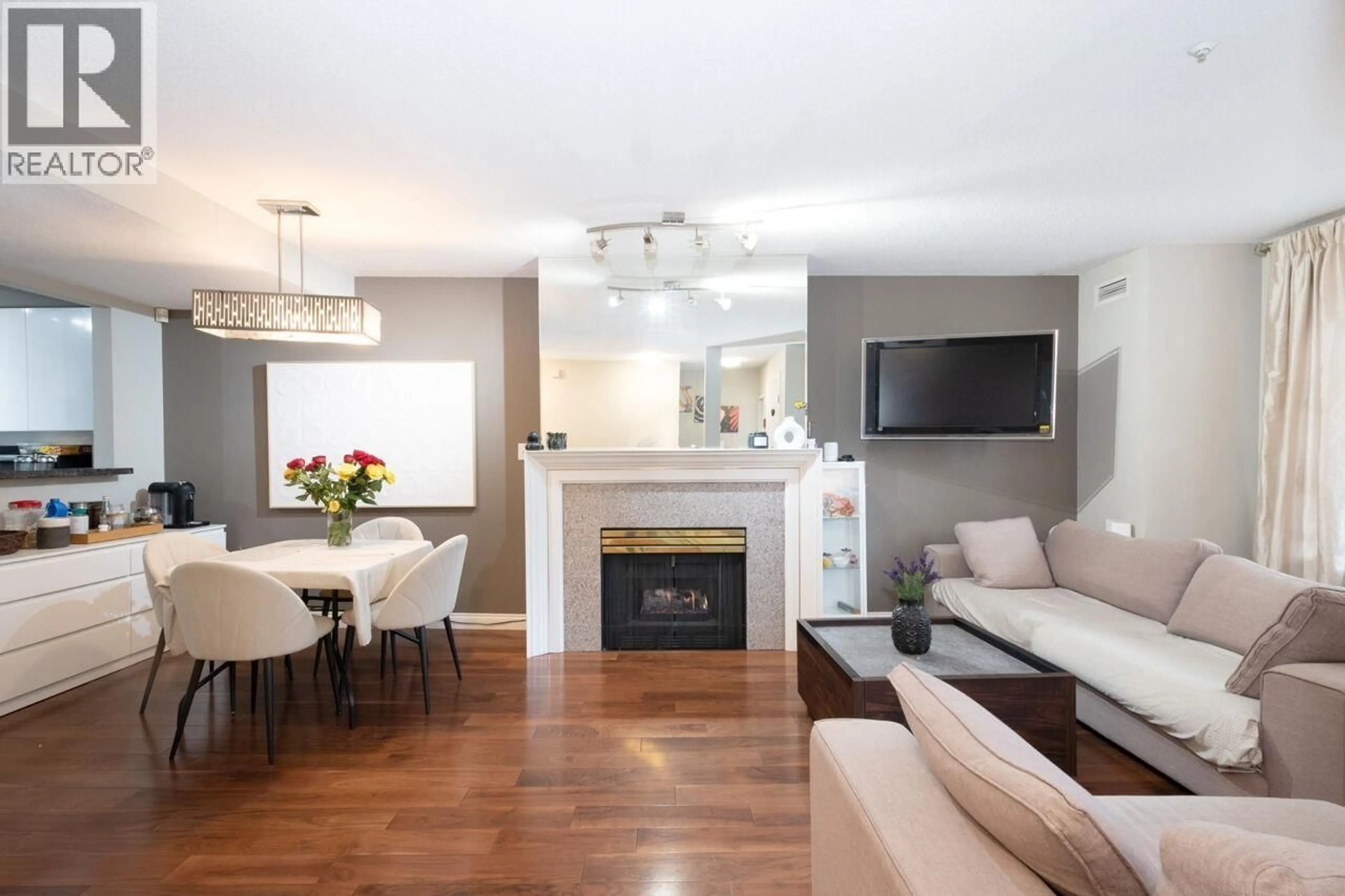 Living room with furniture, wood/laminate floor for 108E - 3081 GLEN DRIVE, Coquitlam British Columbia V3B2P8