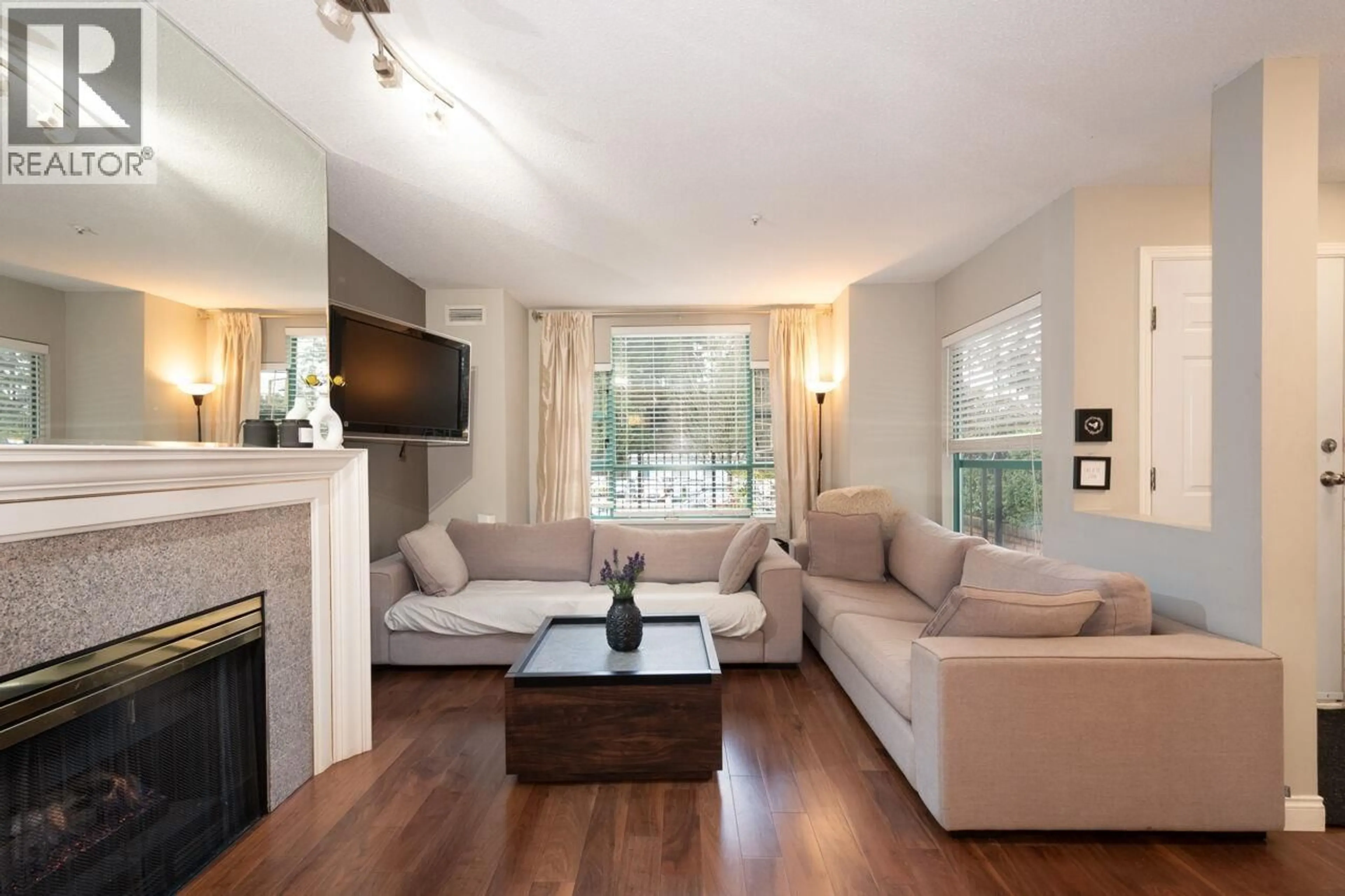 Living room with furniture, wood/laminate floor for 108E - 3081 GLEN DRIVE, Coquitlam British Columbia V3B2P8