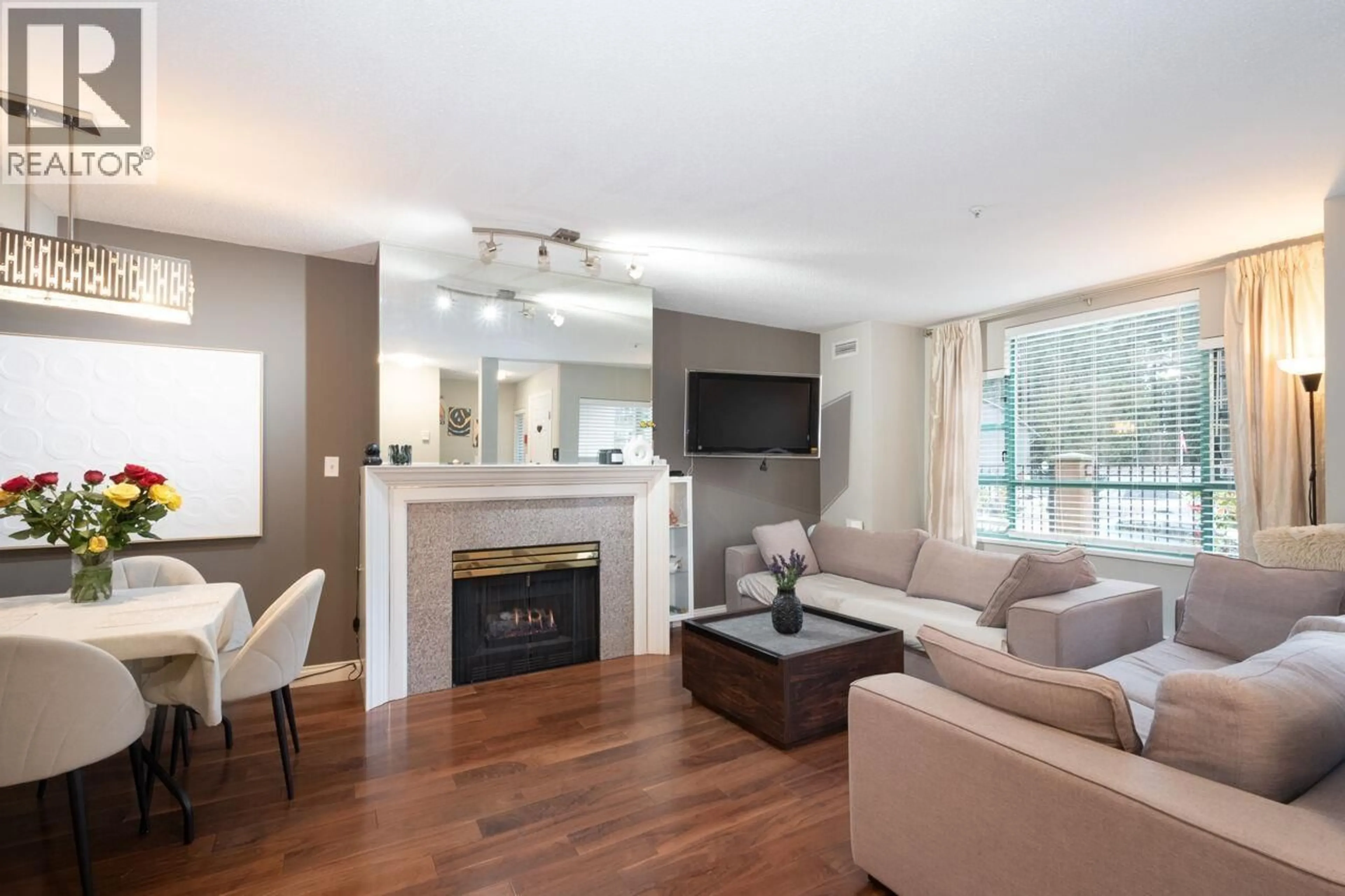 Living room with furniture, wood/laminate floor for 108E - 3081 GLEN DRIVE, Coquitlam British Columbia V3B2P8