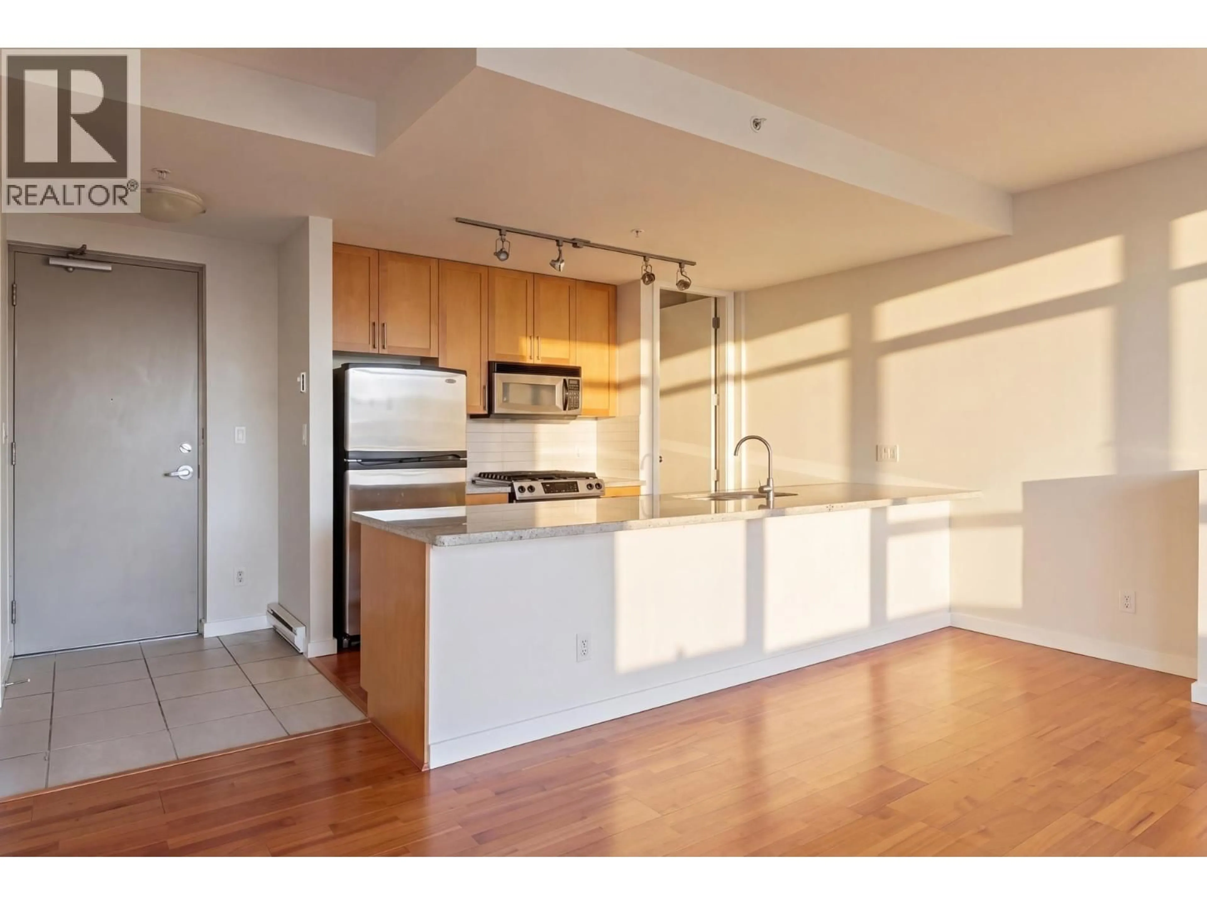 Open concept kitchen, wood/laminate floor for 705 - 2055 YUKON STREET, Vancouver British Columbia V5Y4B7