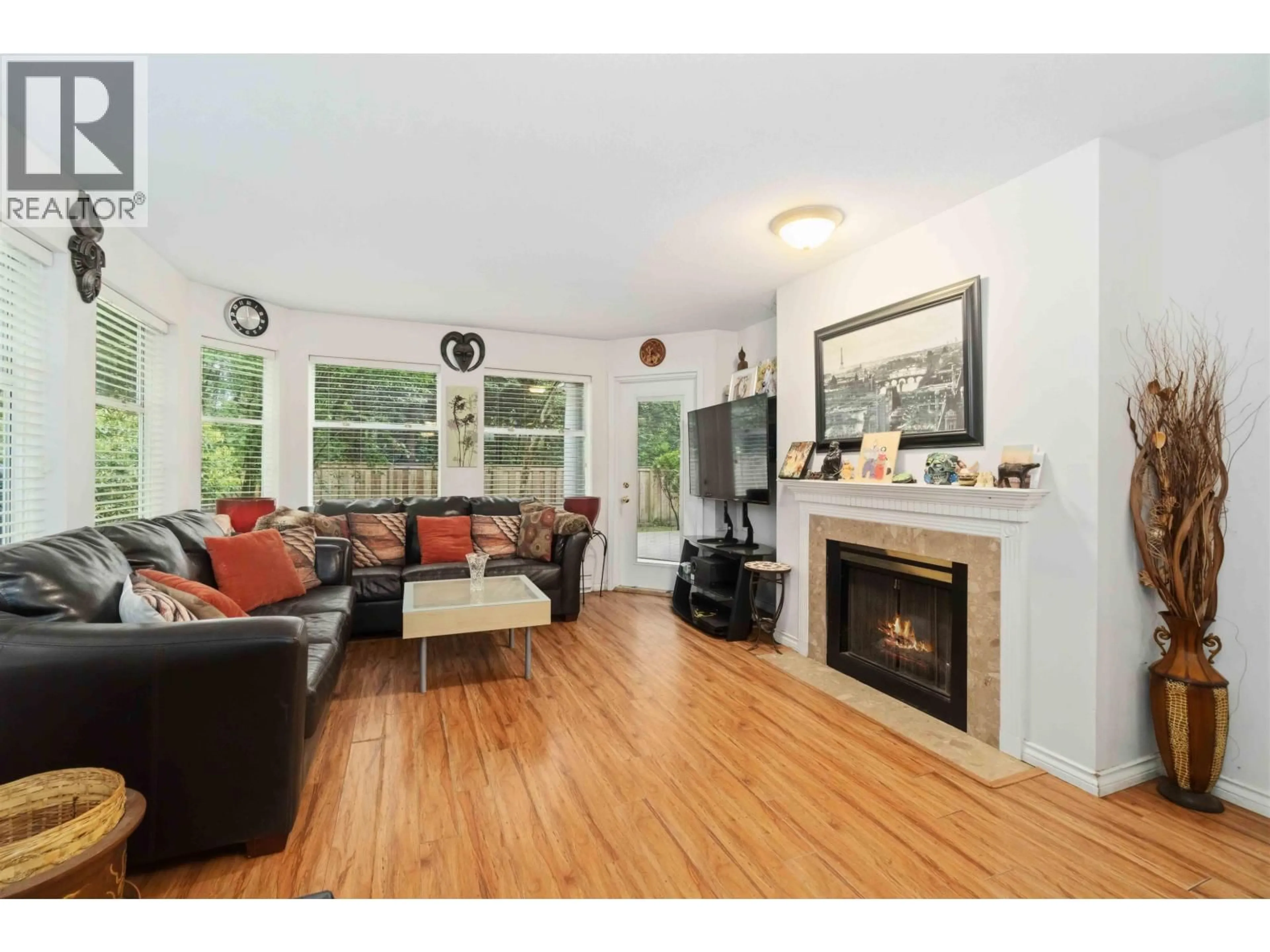 Living room with furniture, wood/laminate floor for 108 - 6860 RUMBLE STREET, Burnaby British Columbia V5E1A8