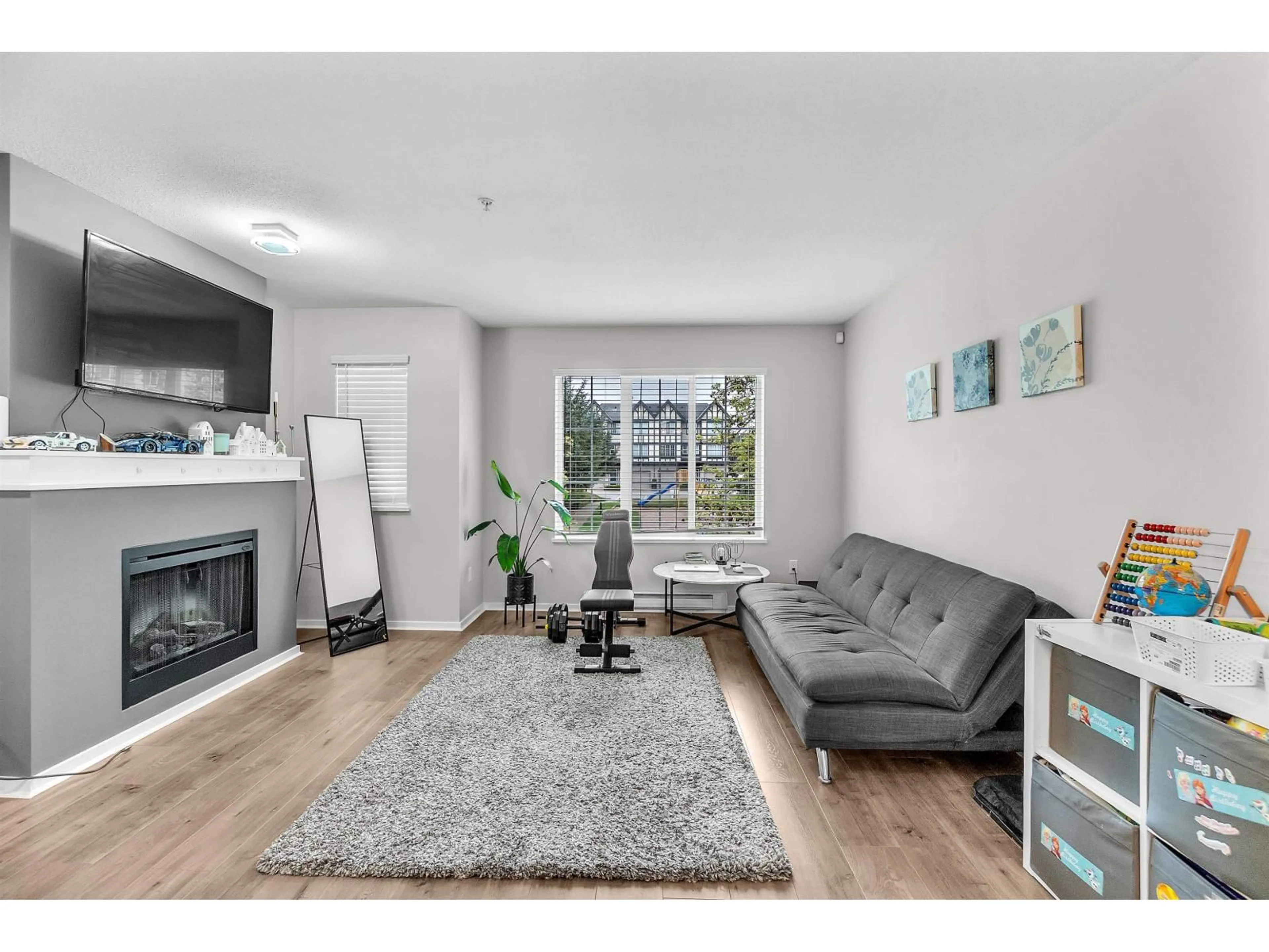 Living room with furniture, wood/laminate floor for 150 - 20875 80 AVENUE, Langley British Columbia V2Y0B2