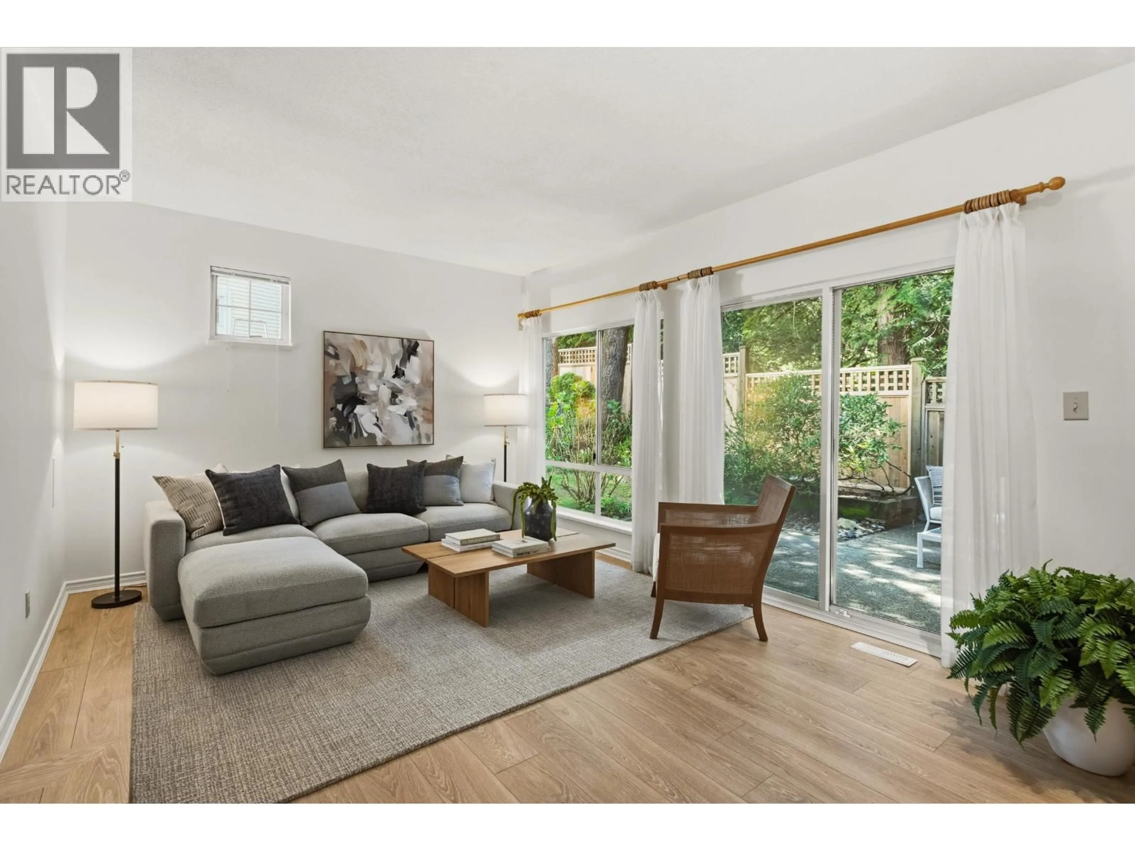 Living room with furniture, wood/laminate floor for 10 - 3939 INDIAN RIVER DRIVE, North Vancouver British Columbia V7G2P5