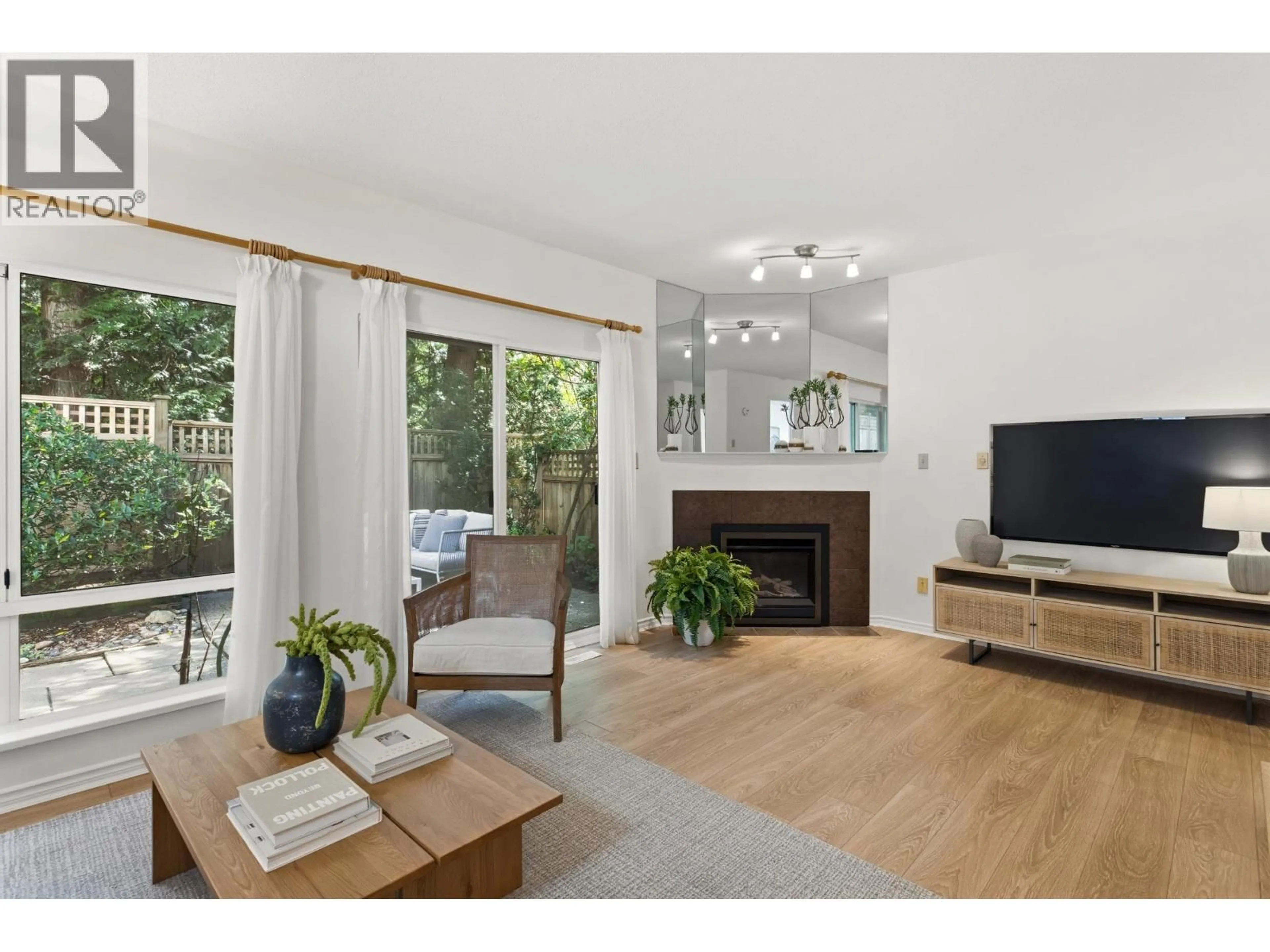 Living room with furniture, wood/laminate floor for 10 - 3939 INDIAN RIVER DRIVE, North Vancouver British Columbia V7G2P5