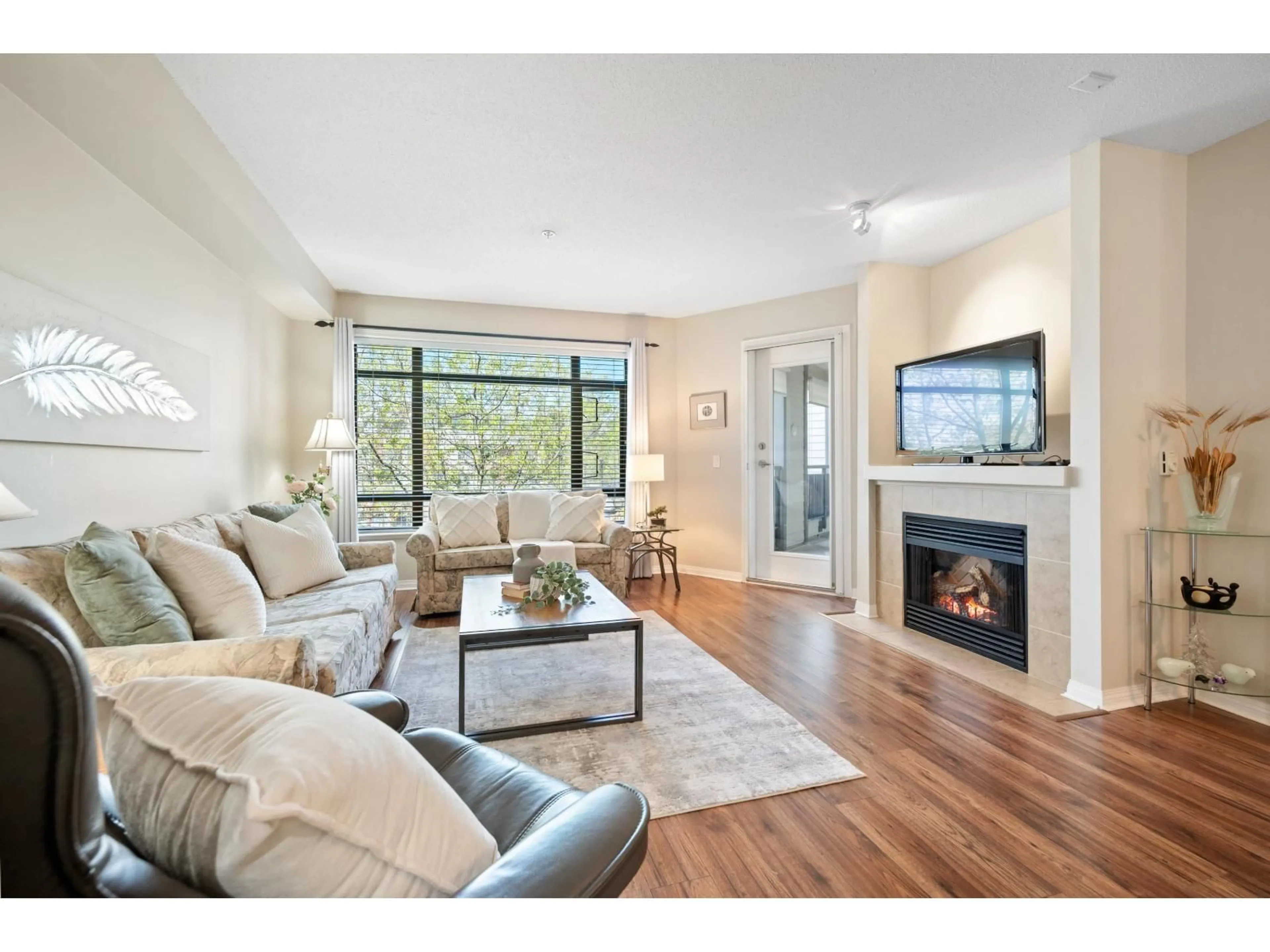 Living room with furniture, wood/laminate floor for 205 - 8880 202 STREET, Langley British Columbia V1M4E7