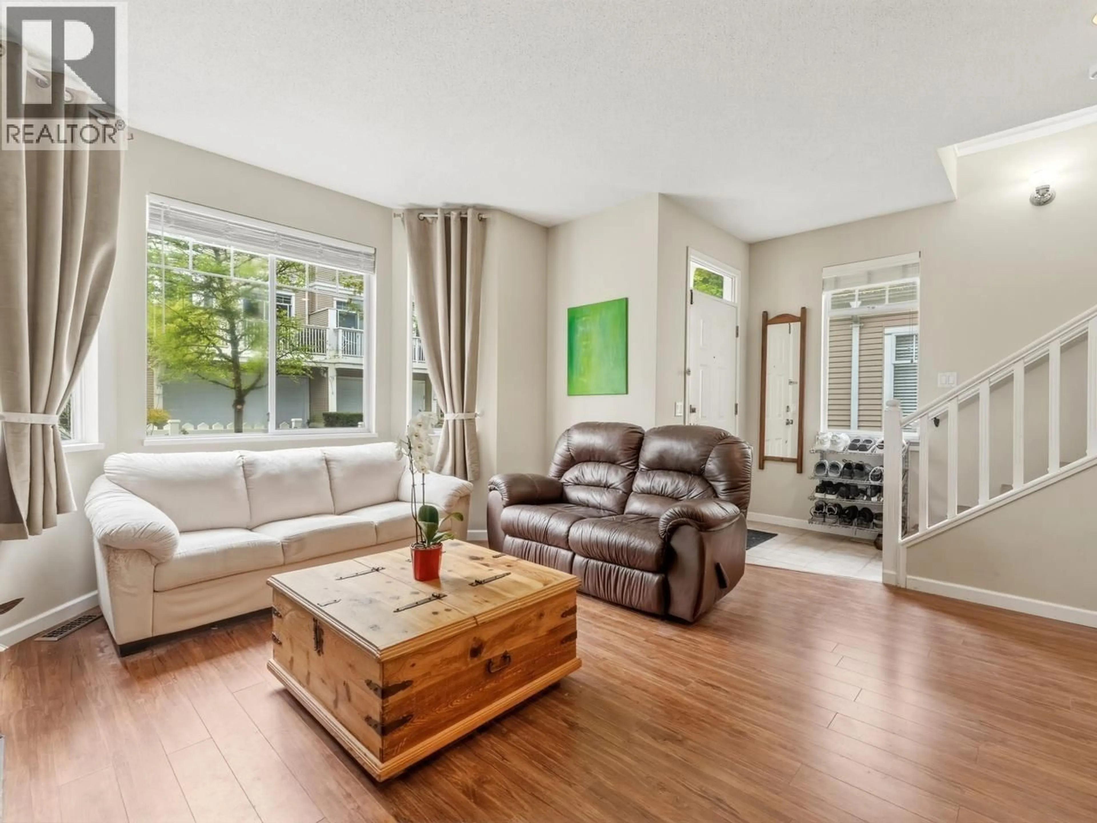 Living room with furniture, wood/laminate floor for 76 - 7501 CUMBERLAND STREET, Burnaby British Columbia V3N4Y6