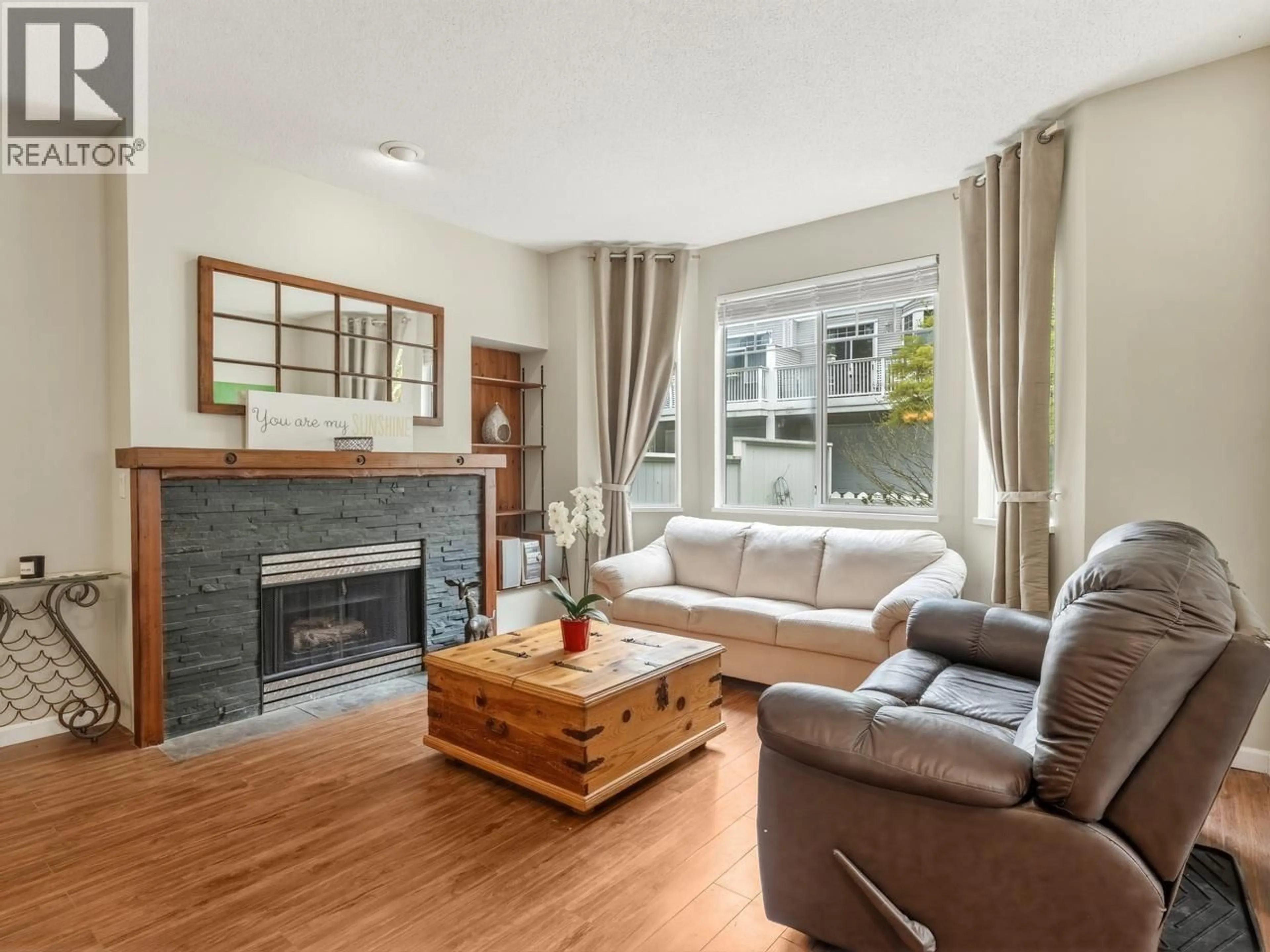 Living room with furniture, wood/laminate floor for 76 - 7501 CUMBERLAND STREET, Burnaby British Columbia V3N4Y6
