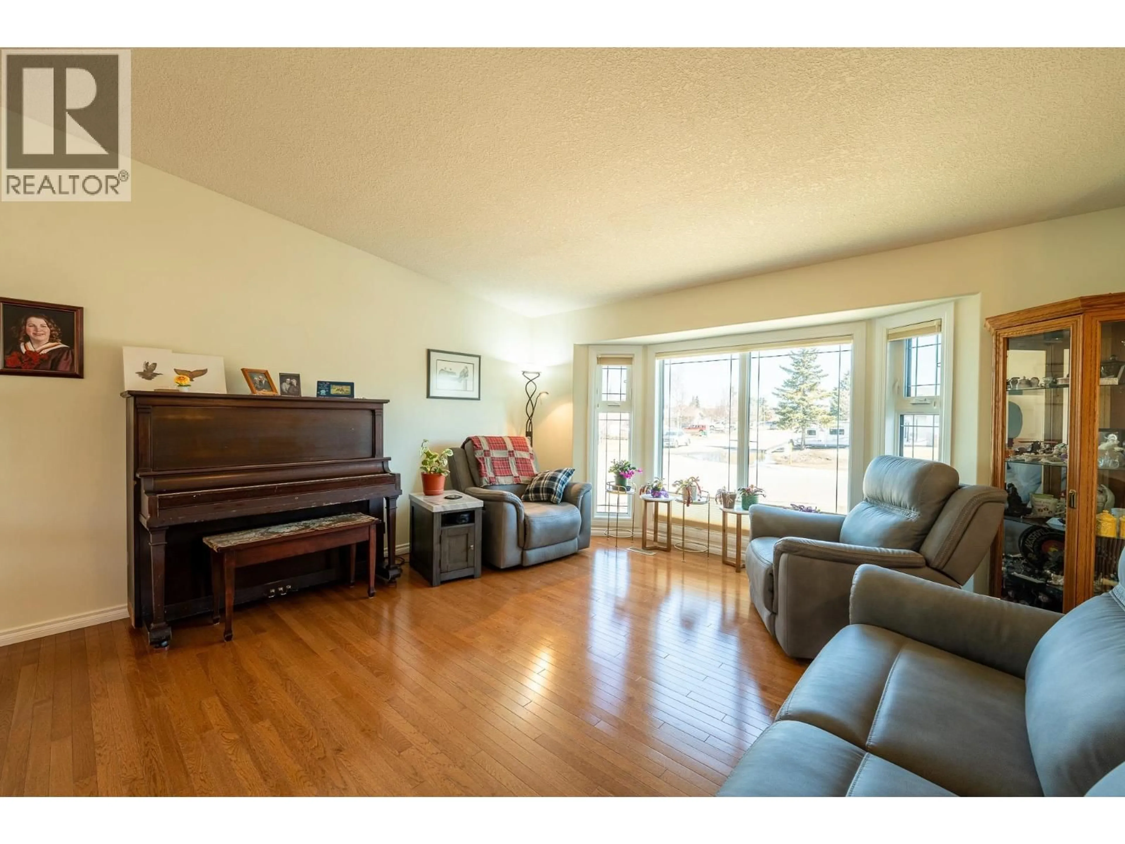 Living room with furniture, wood/laminate floor for 11316 106 STREET, Fort St. John British Columbia V1J6H6