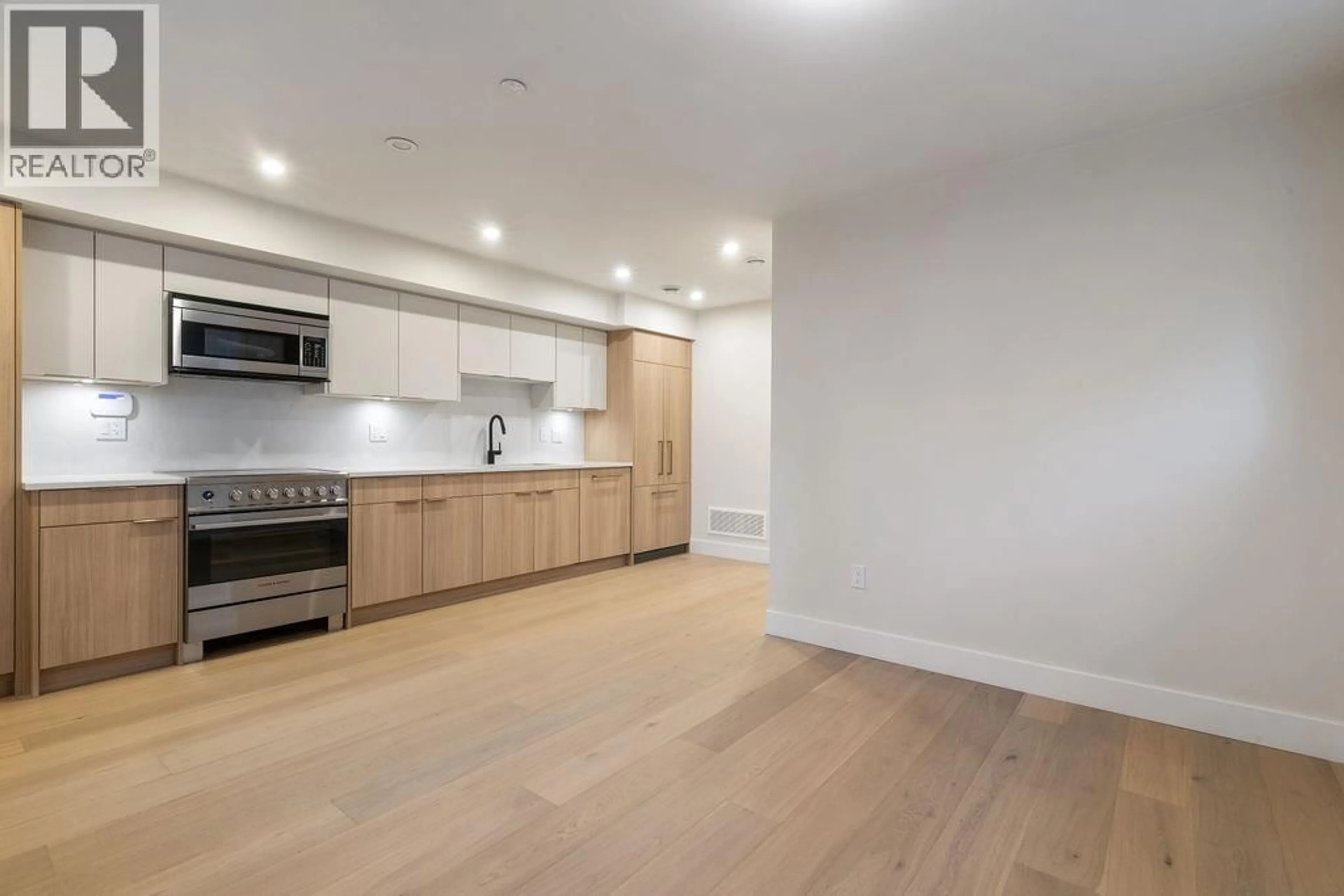 Open concept kitchen, wood/laminate floor for 1 - 1933 TEMPLETON DRIVE, Vancouver British Columbia V5N4V9