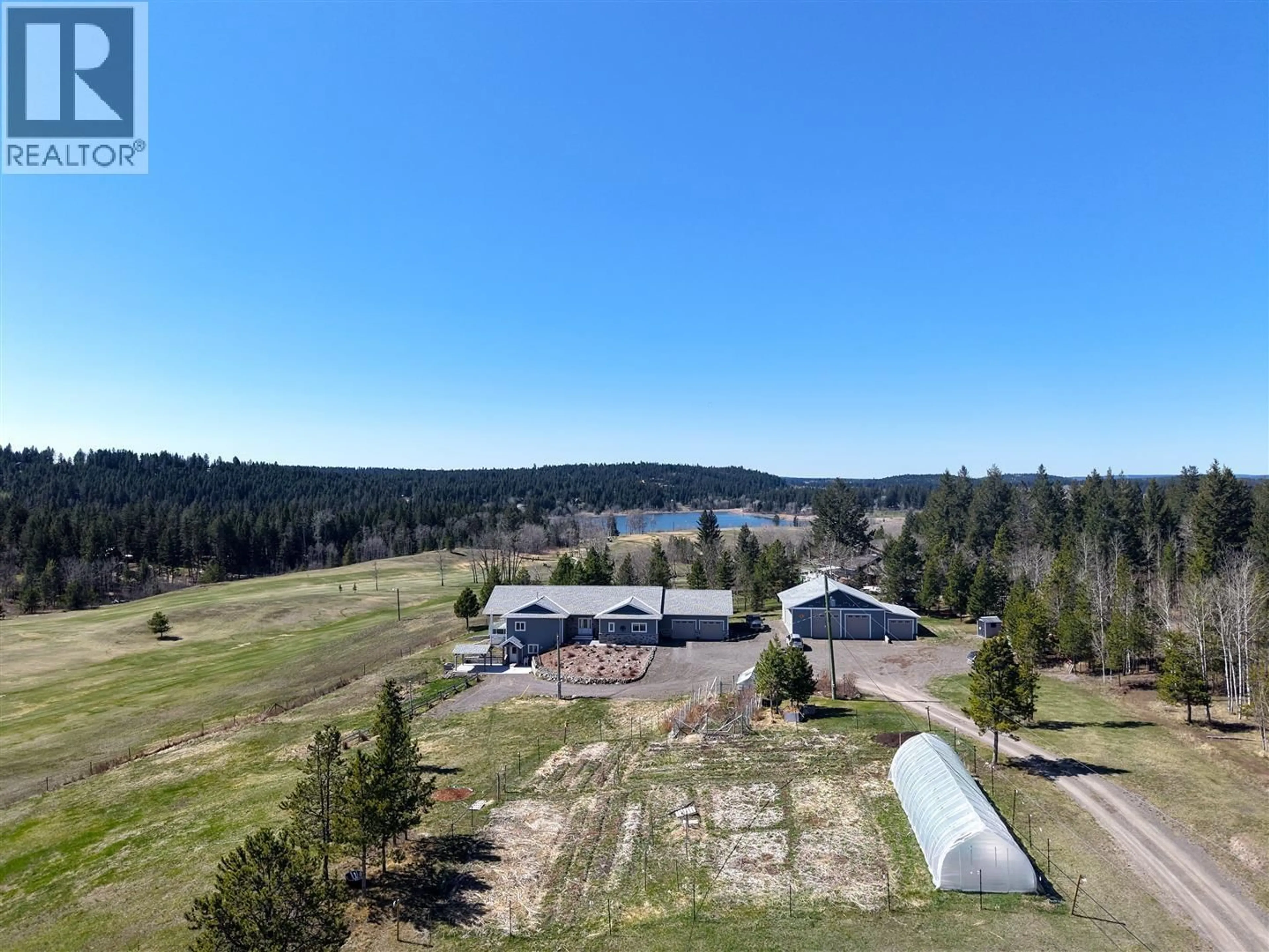 A pic from outside/outdoor area/front of a property/back of a property/a pic from drone, water/lake/river/ocean view for 4898 TELQUA DRIVE, 108 Mile Ranch British Columbia V0K2Z0