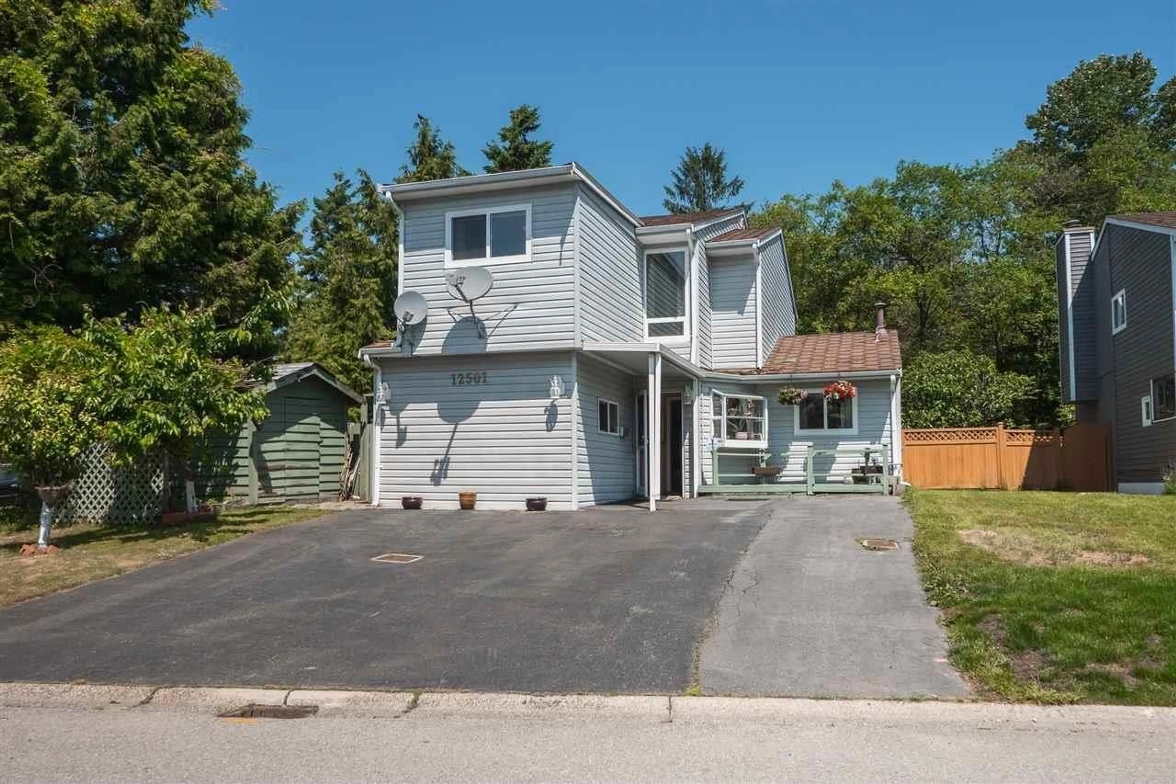 Home with vinyl exterior material, street for 12501 76A AVENUE, Surrey British Columbia V3W7W5