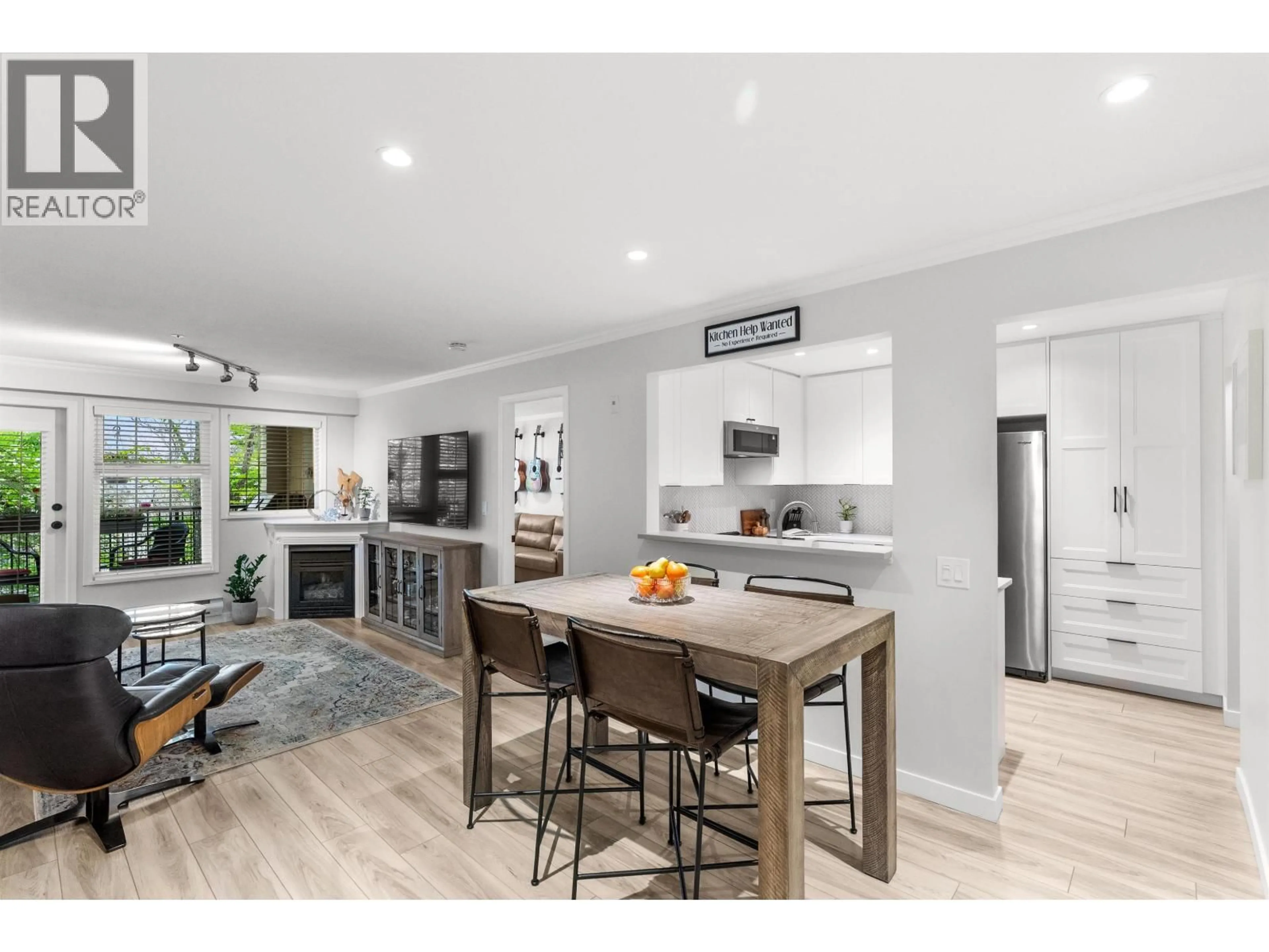 Open concept kitchen, wood/laminate floor for 304 - 5556 14 AVENUE, Delta British Columbia V4M4E7