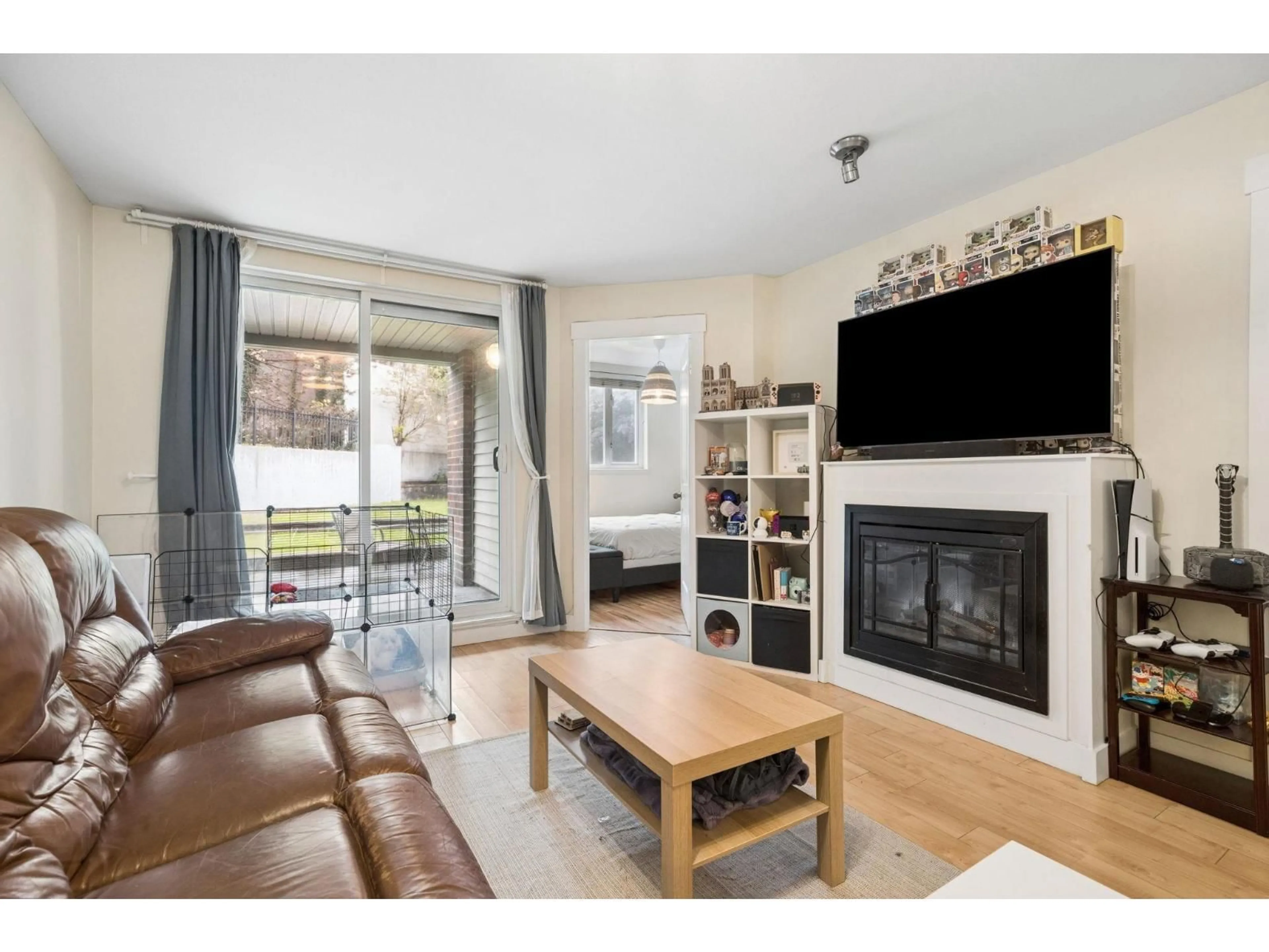 Living room with furniture, wood/laminate floor for 111 - 10822 CITY PARKWAY, Surrey British Columbia V3T0C2