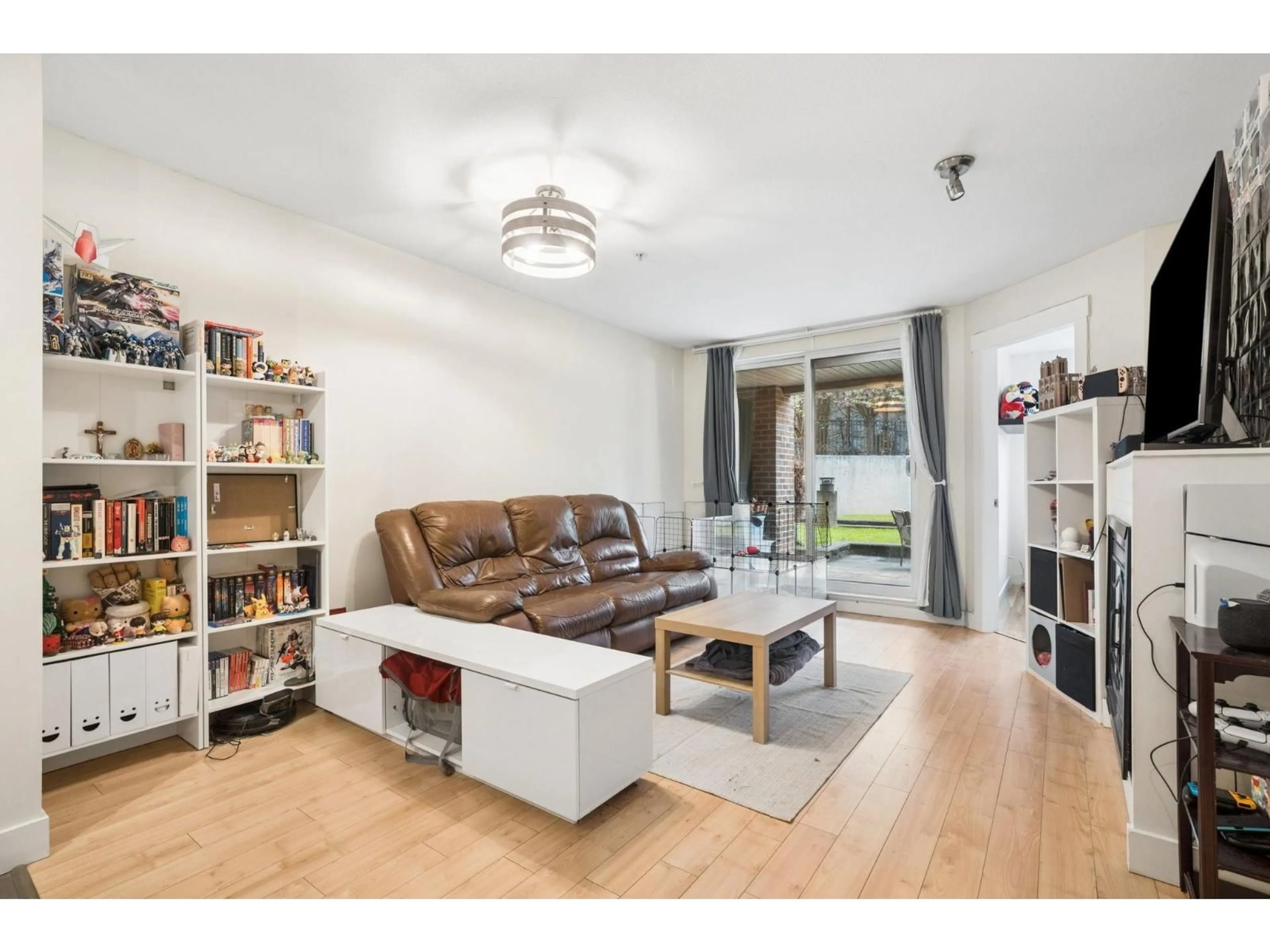 Living room with furniture, wood/laminate floor for 111 - 10822 CITY PARKWAY, Surrey British Columbia V3T0C2