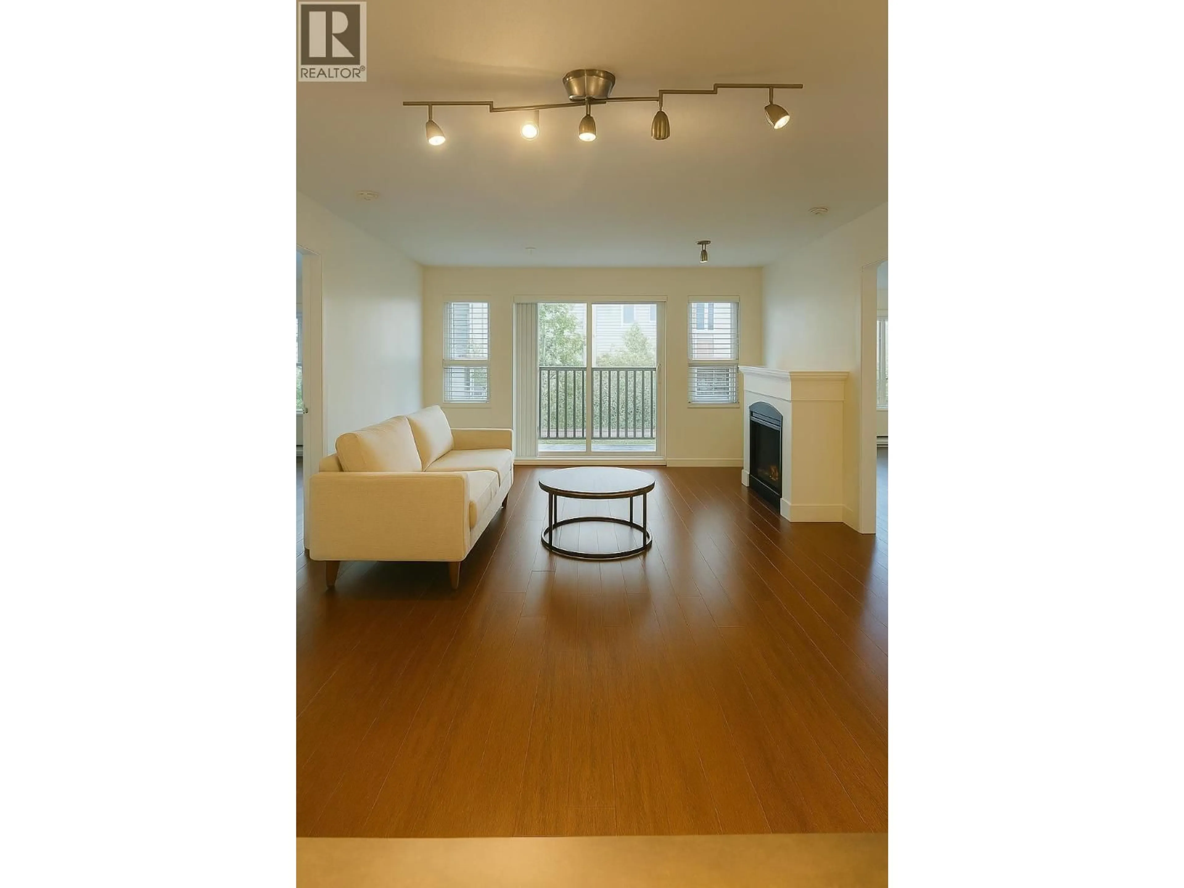 Living room with furniture, wood/laminate floor for 303 - 2958 WHISPER WAY, Coquitlam British Columbia V3E3S7