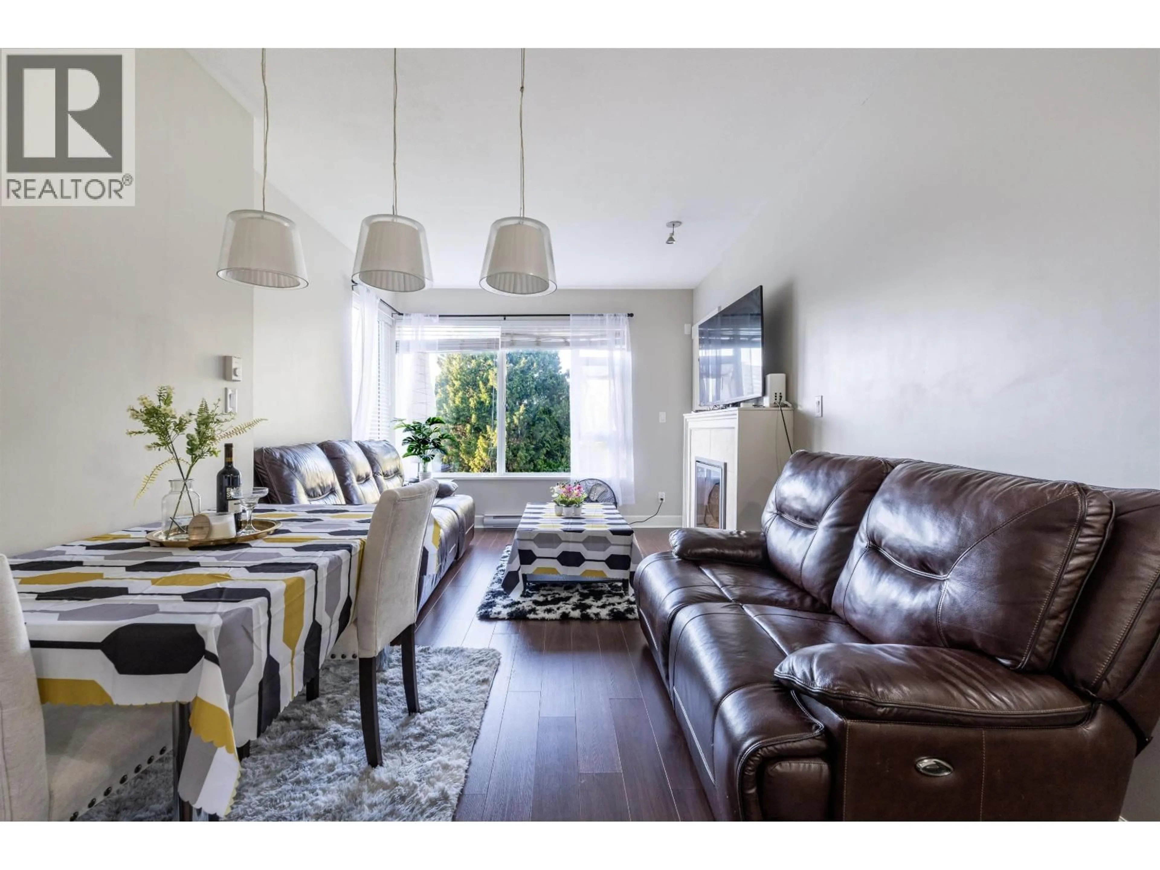 Living room with furniture, wood/laminate floor for 206 - 6611 ECKERSLEY ROAD, Richmond British Columbia V6Y2E7