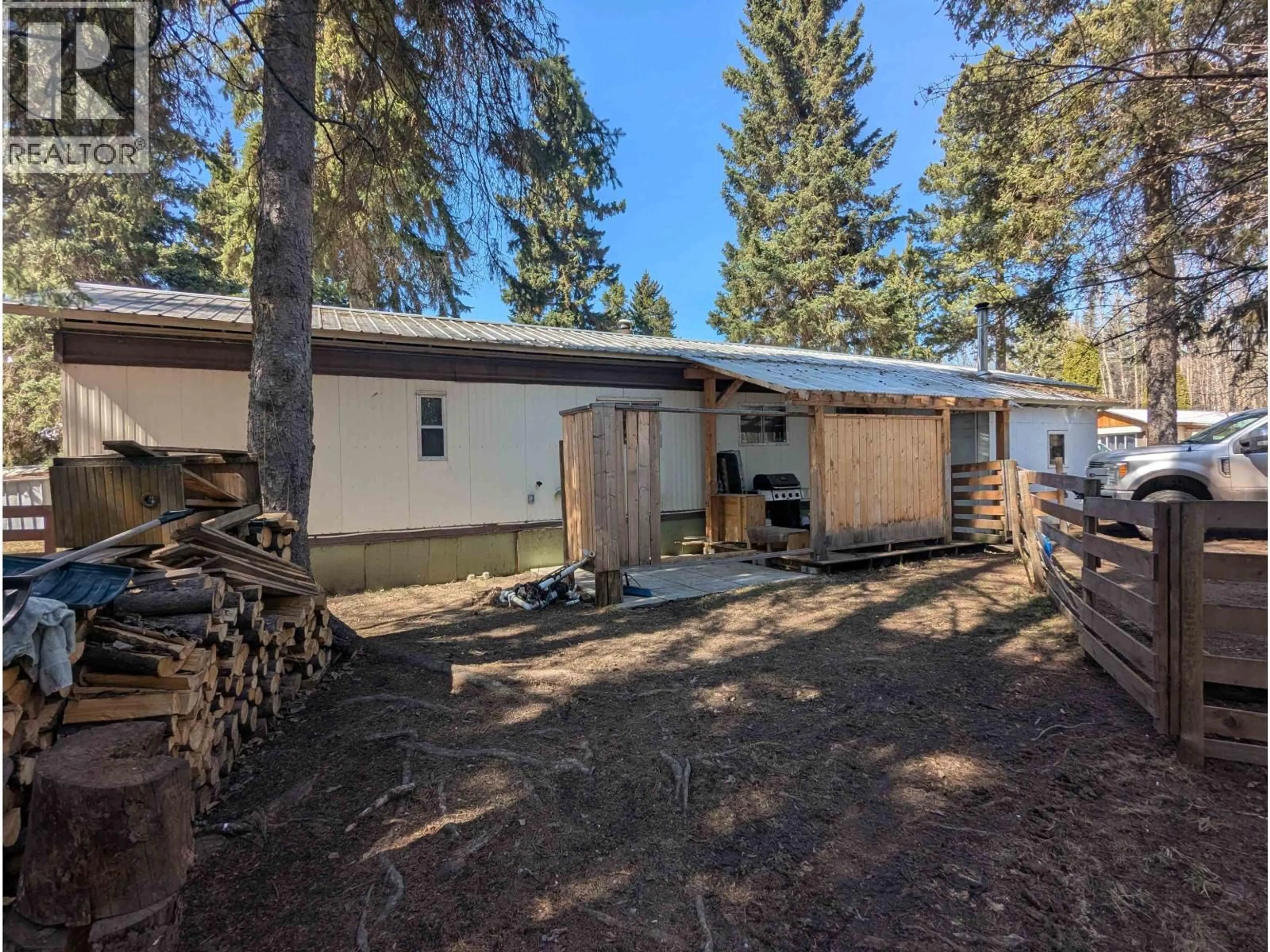 A pic from outside/outdoor area/front of a property/back of a property/a pic from drone, forest/trees view for 82 - 4430 16 HIGHWAY, Smithers British Columbia V0J2N0