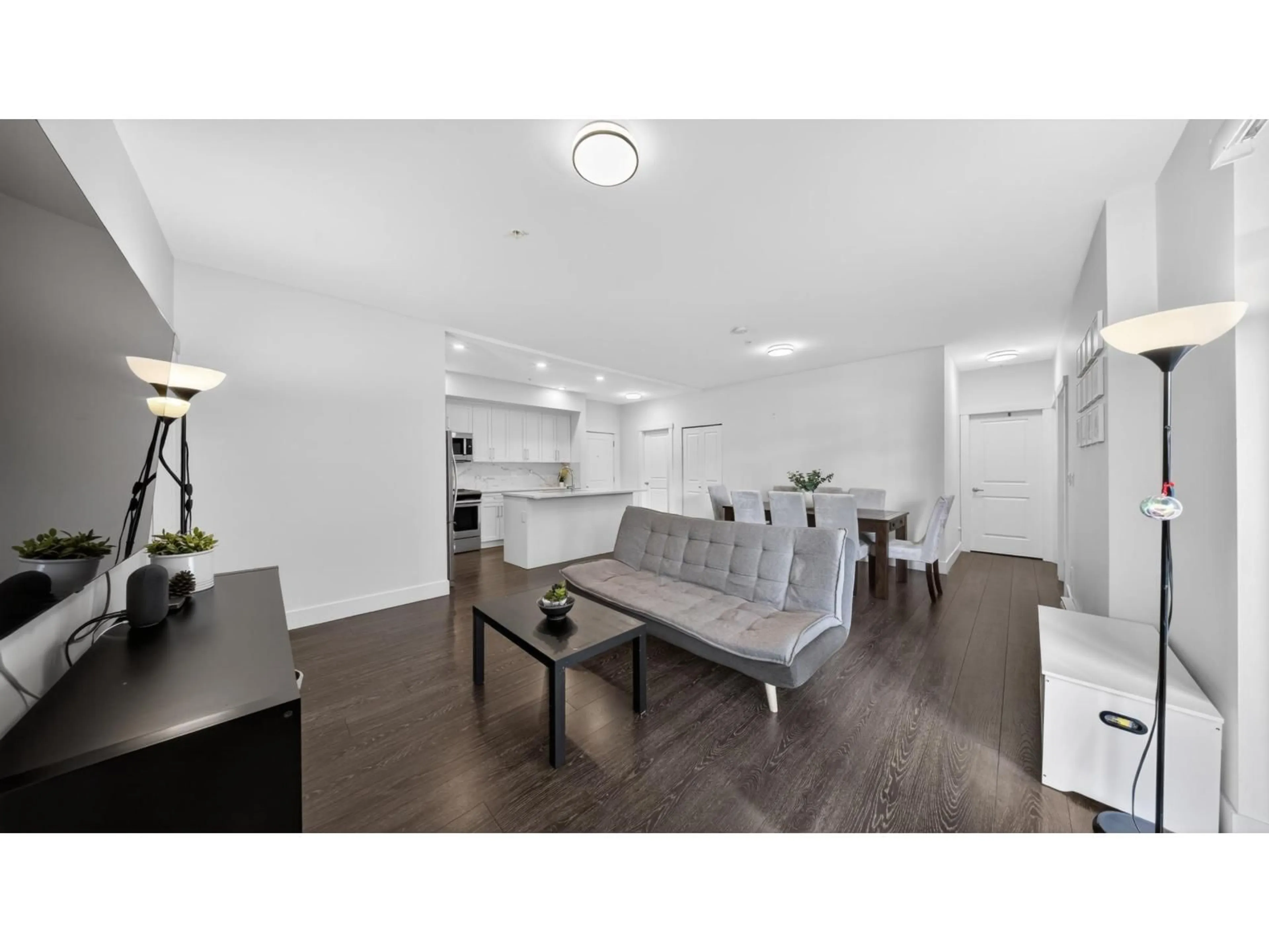 Living room with furniture, wood/laminate floor for 201 - 9983 E BARNSTON DRIVE STREET, Surrey British Columbia V4N6T3