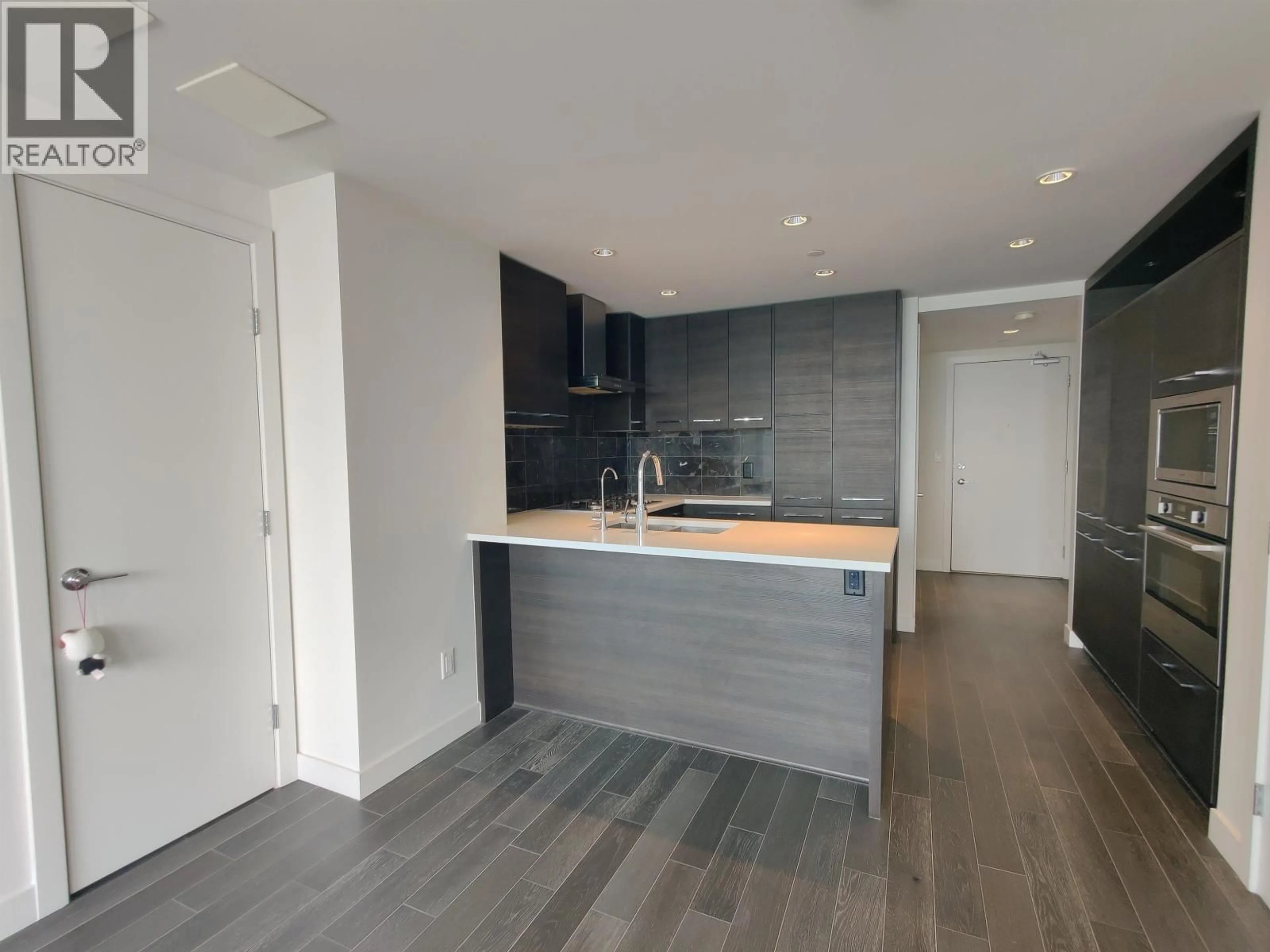 Open concept kitchen, wood/laminate floor for 1607 - 7468 LANSDOWNE ROAD, Richmond British Columbia V7C0B7