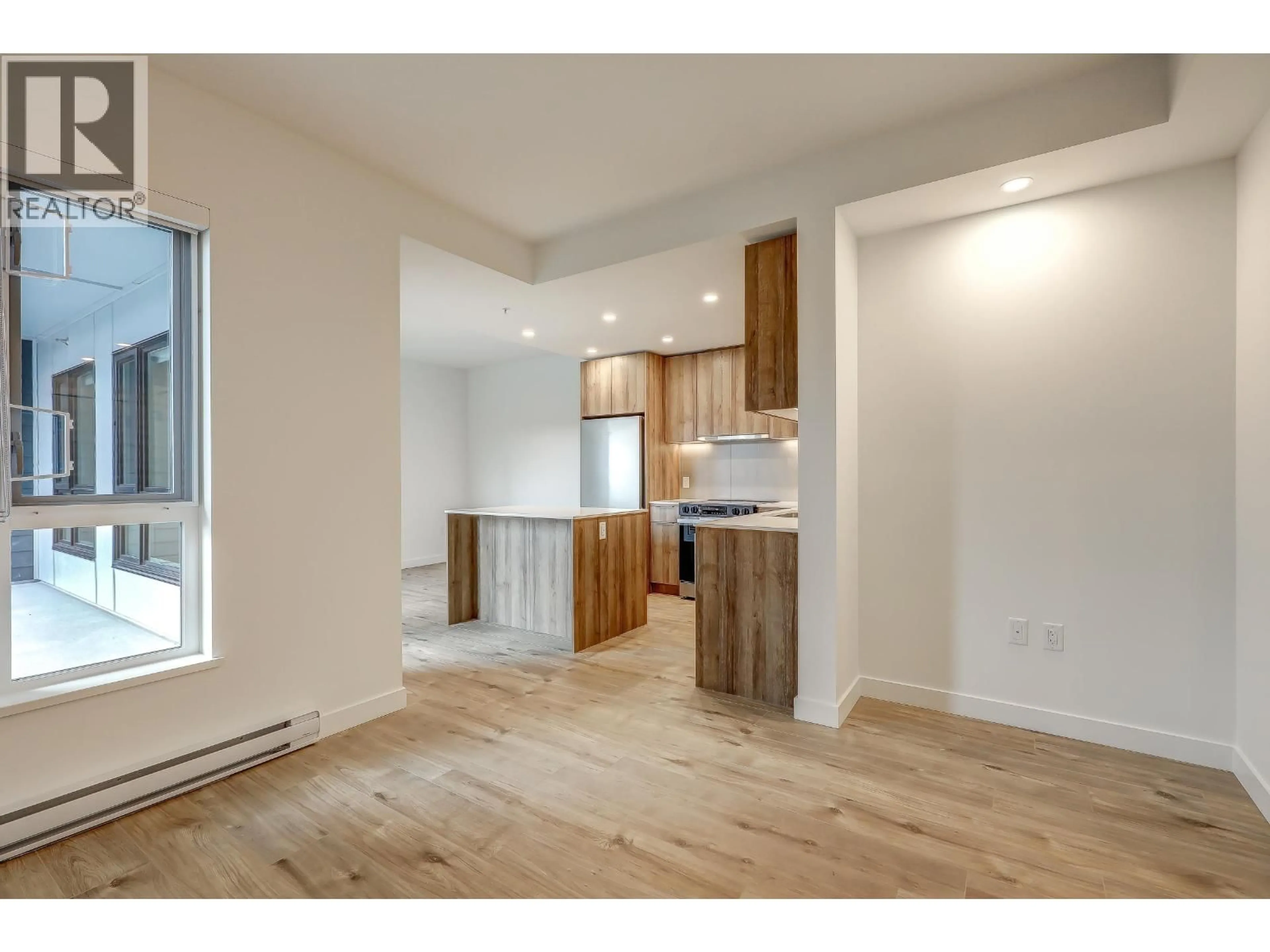 Open concept kitchen, wood/laminate floor for 206 - 3594 MALSUM DRIVE, North Vancouver British Columbia V7G0B5