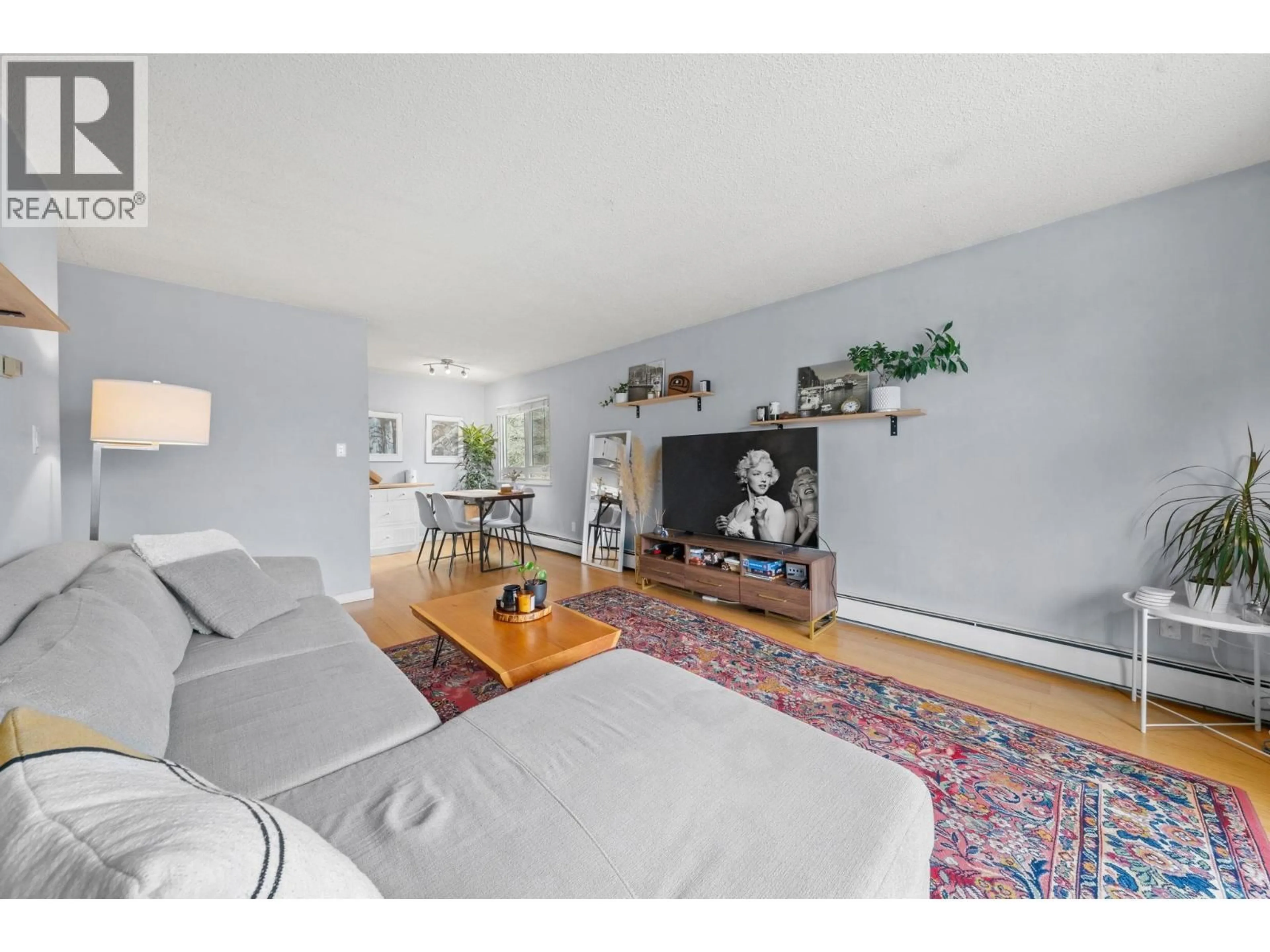 Living room with furniture, wood/laminate floor for 312 - 131 4TH STREET, North Vancouver British Columbia V7M3C8