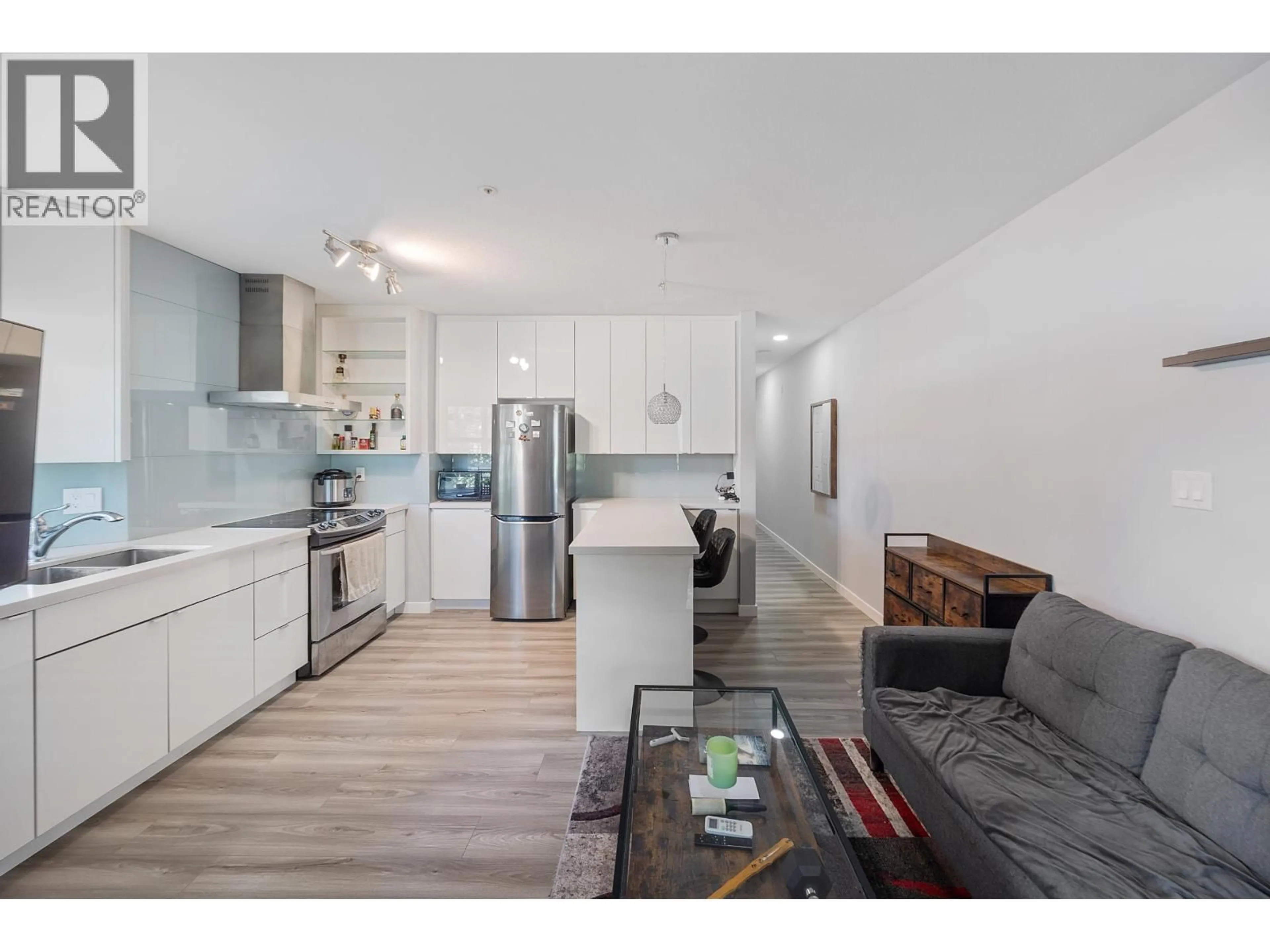 Open concept kitchen, wood/laminate floor for 106 - 1988 37TH AVENUE, Vancouver British Columbia V5P1G1